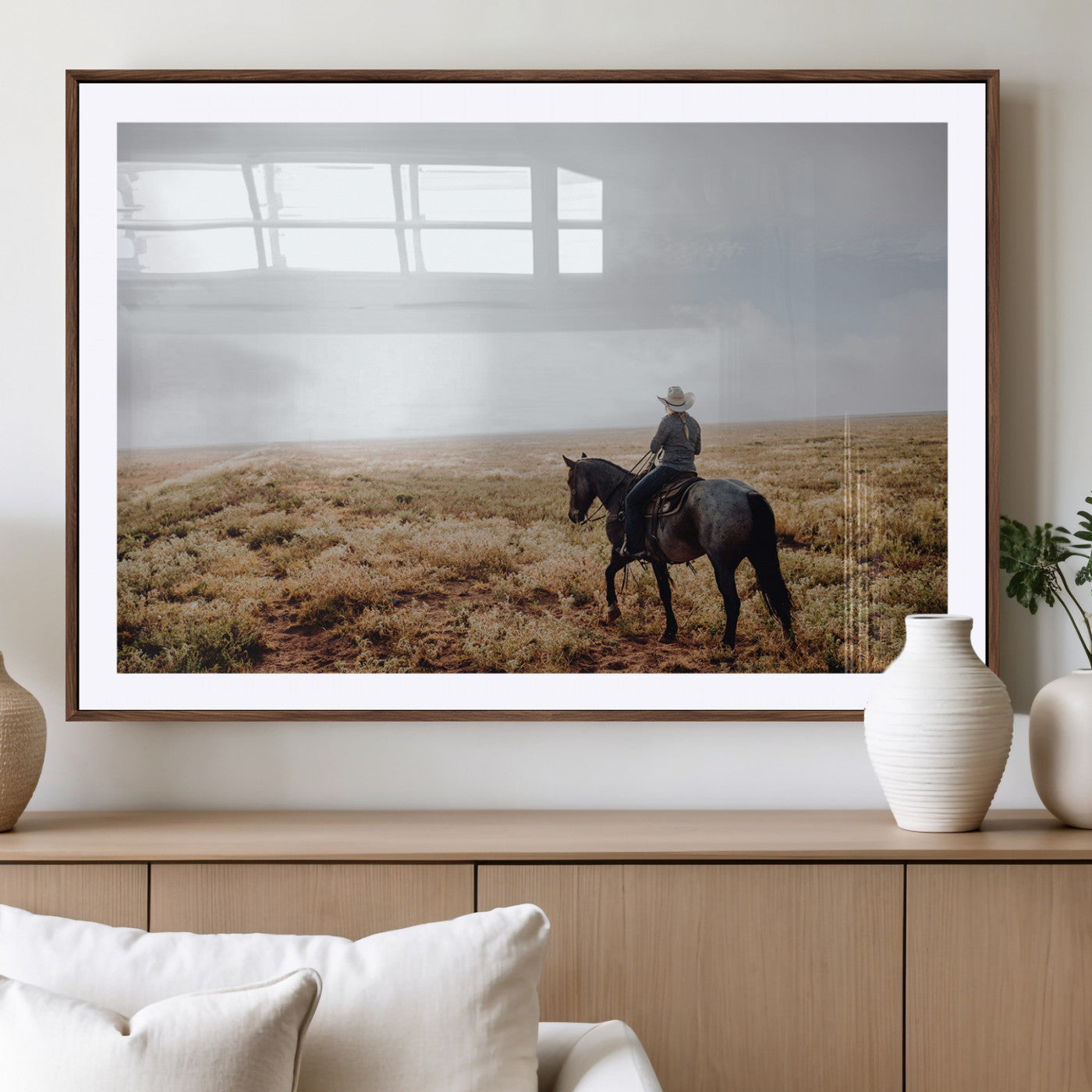 A lone cowboy riding horseback across an open prairie under a vast sky, capturing the rugged and timeless spirit of the Western frontier.
