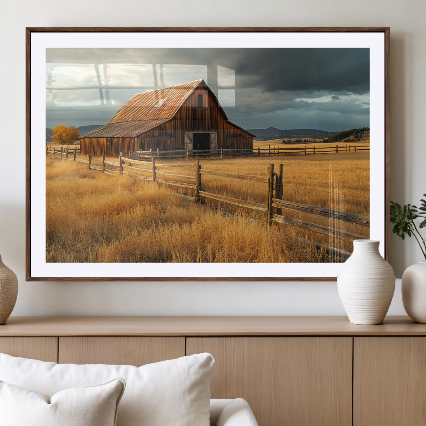 "Golden fields surrounding a rustic barn with a weathered roof, a wooden fence, and dramatic skies with sunlight breaking through the clouds."