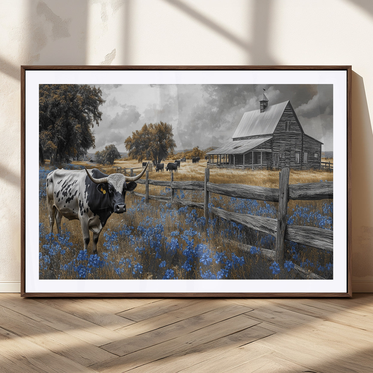 A Texas longhorn stands in front of a rustic barn and wooden fence, with bluebonnets and grazing cattle under dramatic skies.