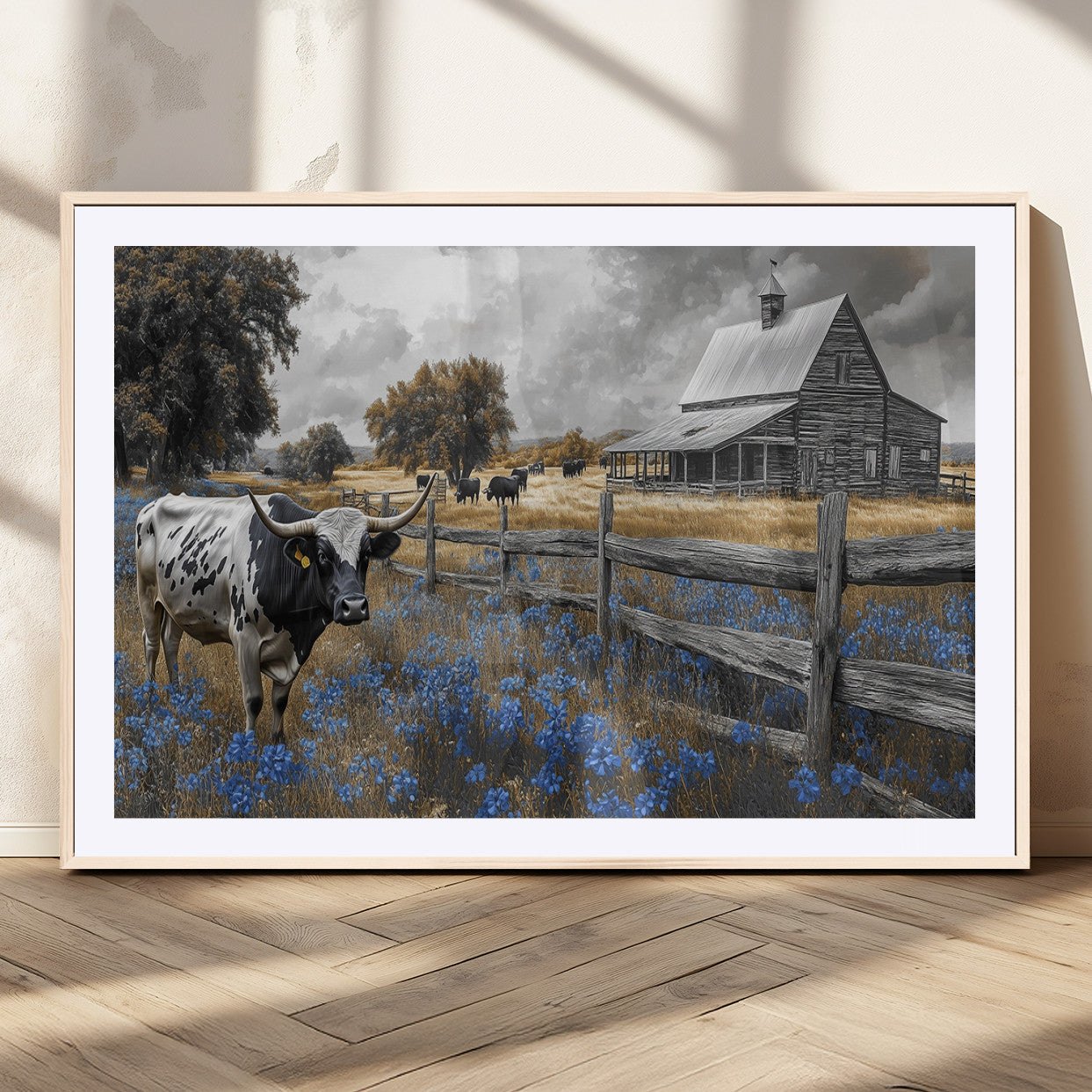 A Texas longhorn stands in front of a rustic barn and wooden fence, with bluebonnets and grazing cattle under dramatic skies.