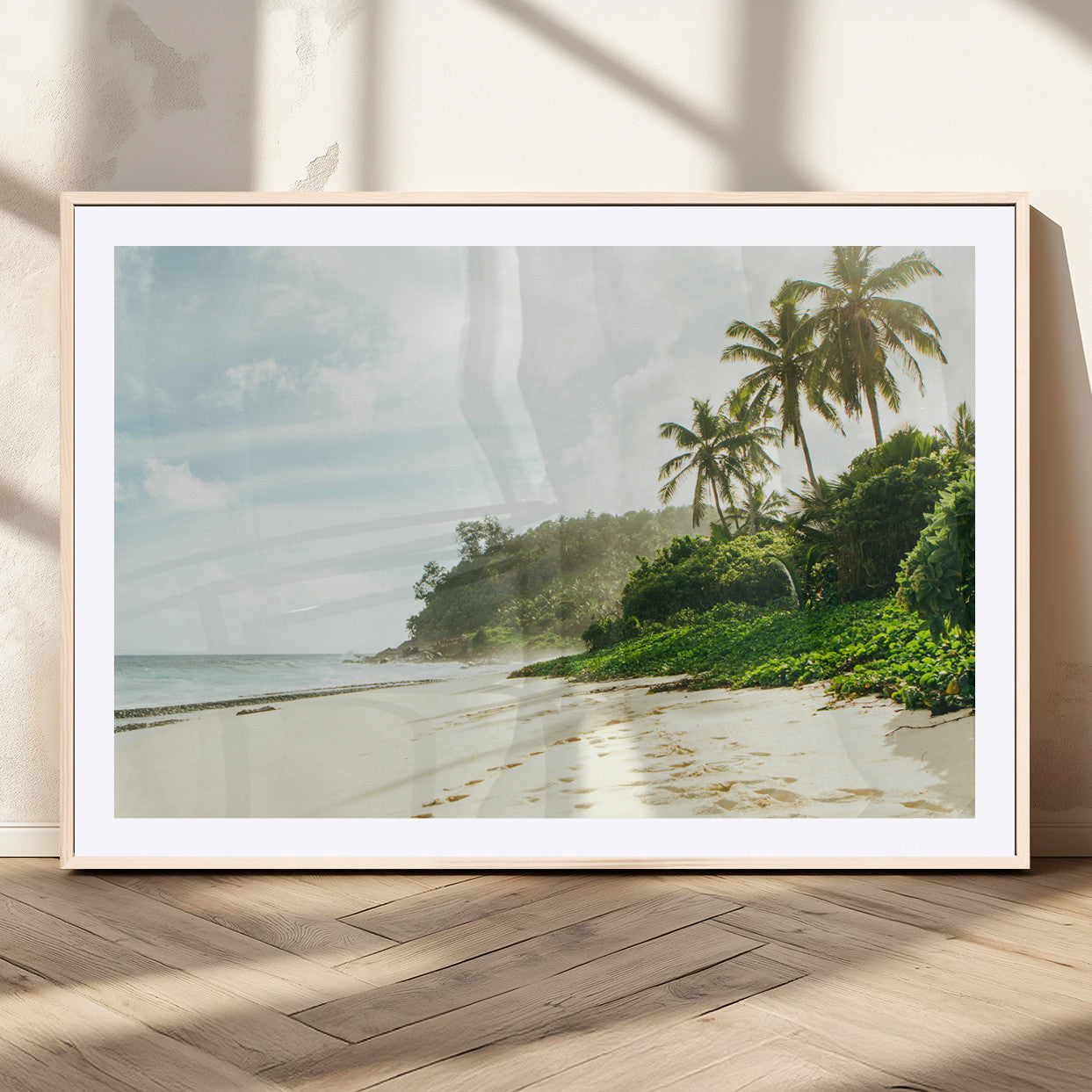 A tropical beach with palm trees, soft sand, and ocean waves under a bright sky, creating a peaceful and relaxing coastal view.