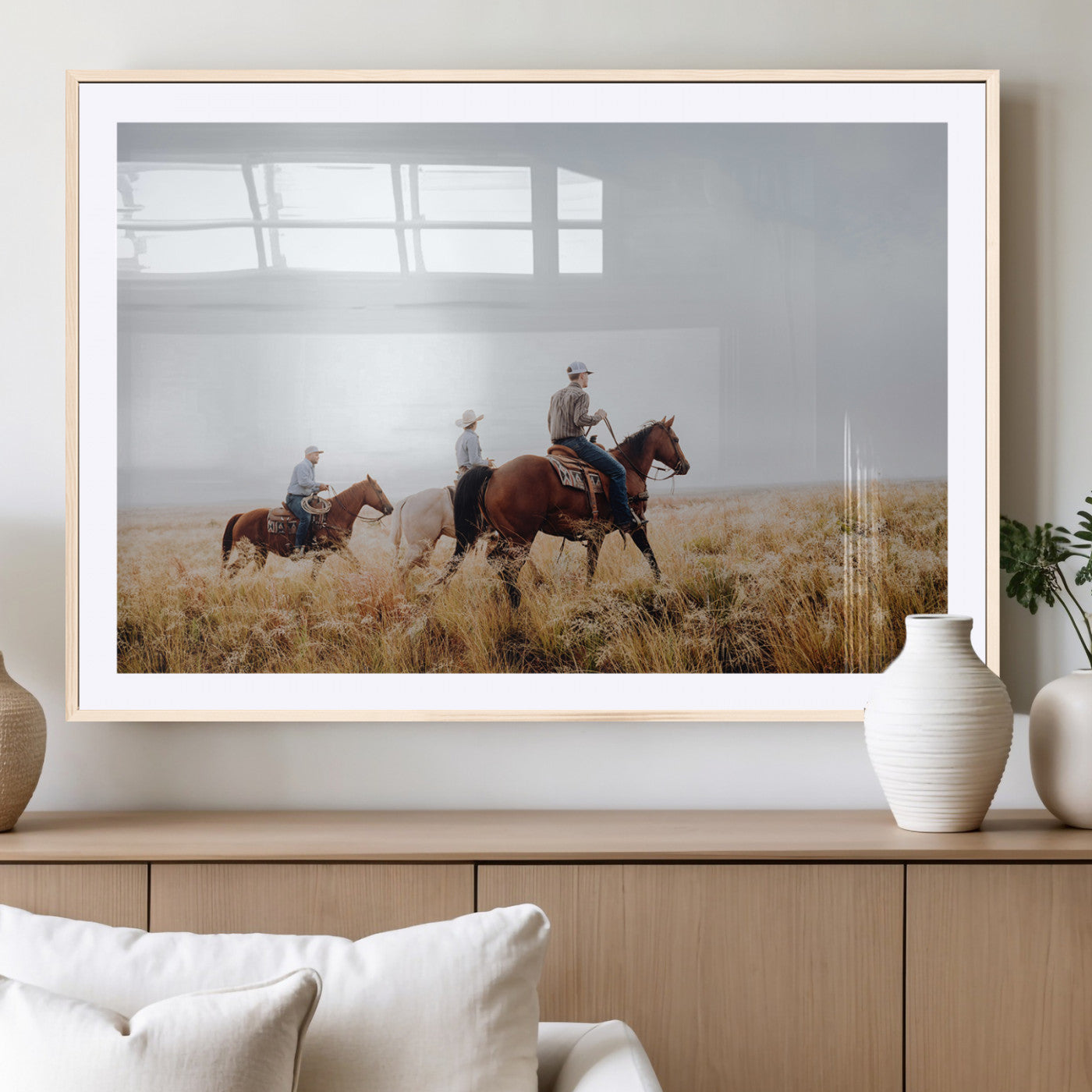Three cowboys riding horses through a foggy prairie landscape, dressed in Western attire, evoking a rustic and adventurous Wild West aesthetic.