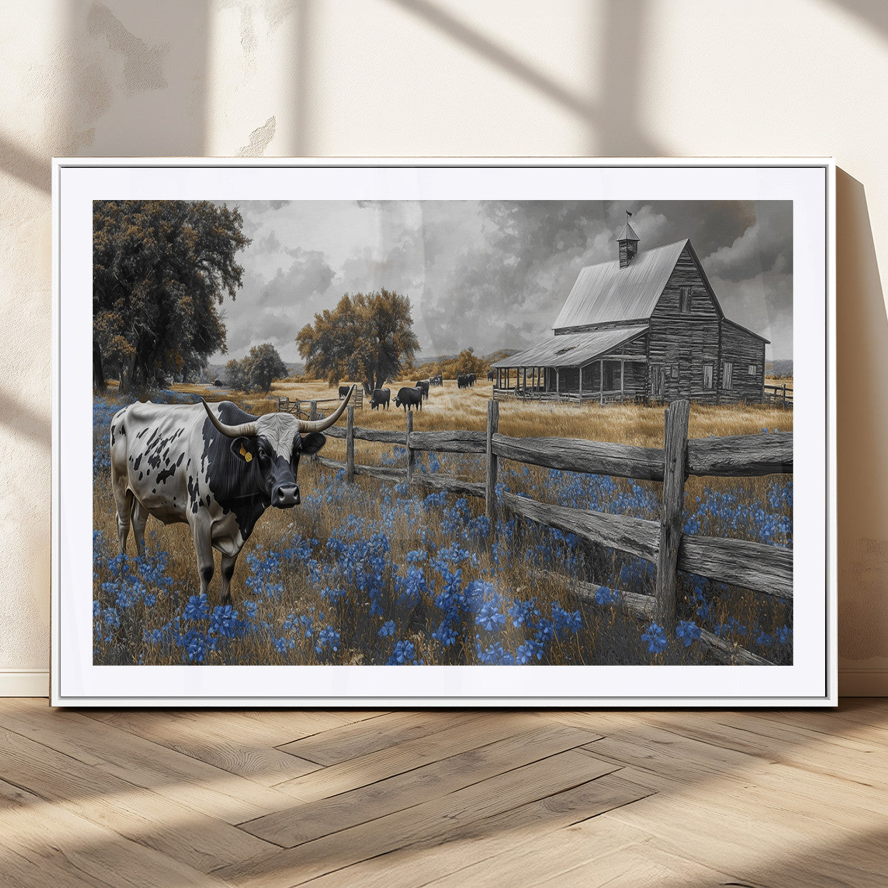 A Texas longhorn stands in front of a rustic barn and wooden fence, with bluebonnets and grazing cattle under dramatic skies.