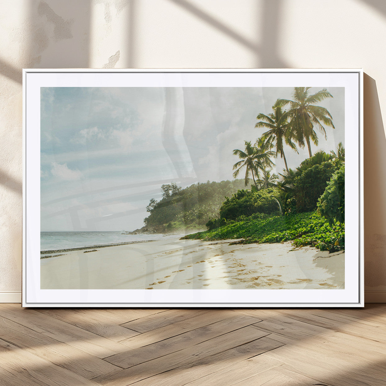 A tropical beach with palm trees, soft sand, and ocean waves under a bright sky, creating a peaceful and relaxing coastal view.