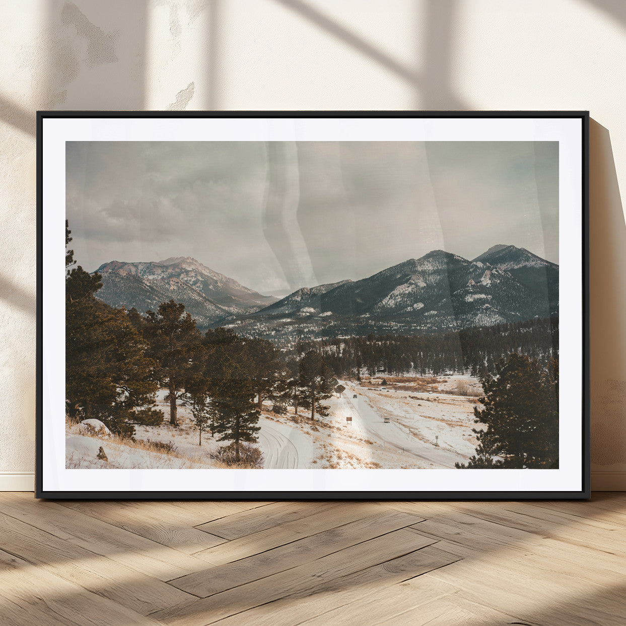 Snow-covered mountains with pine trees and a winding path, creating a serene and rustic winter landscape perfect for cozy decor.