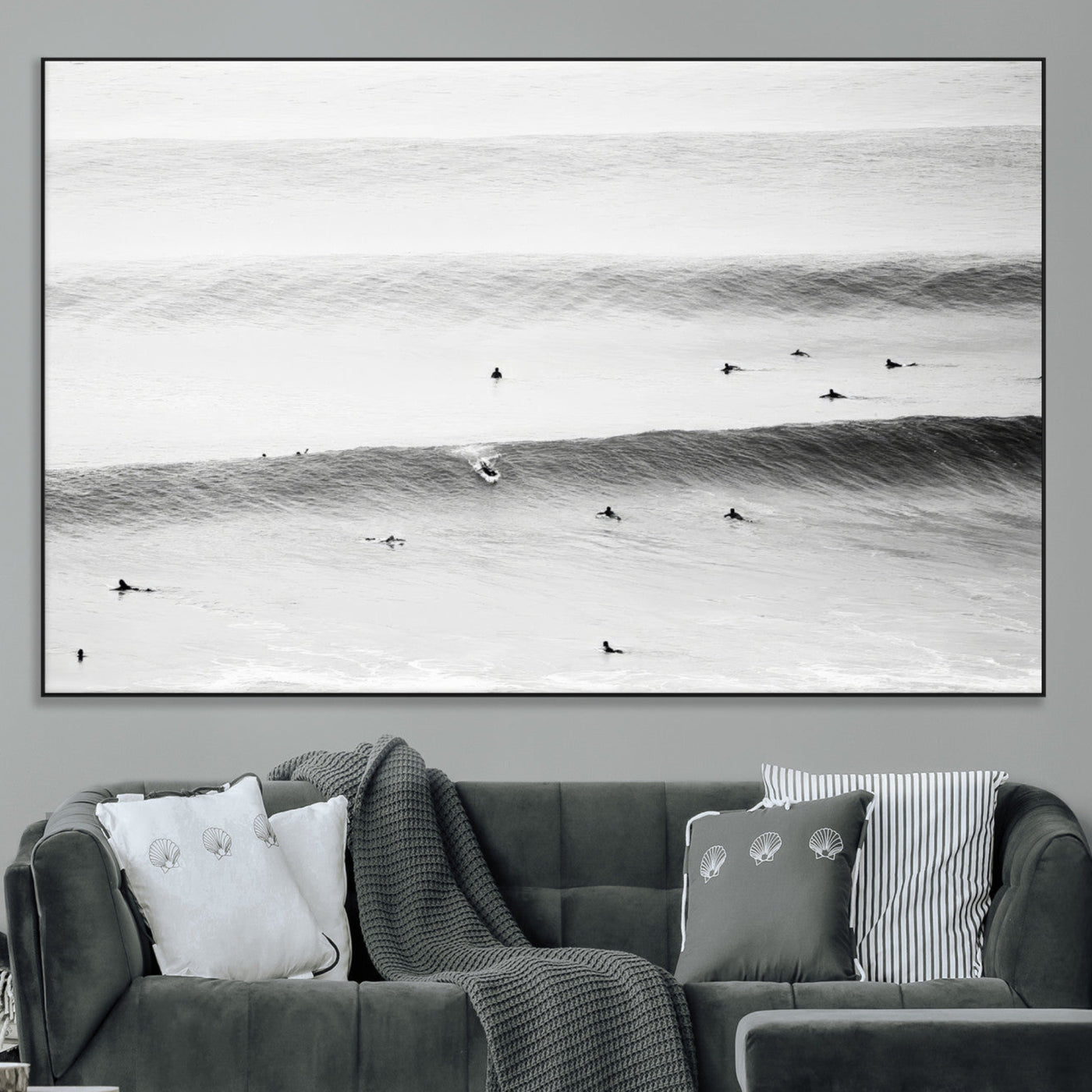 A monochrome photograph of swimmers gliding through gentle ocean waves, evoking a sense of calm and movement.