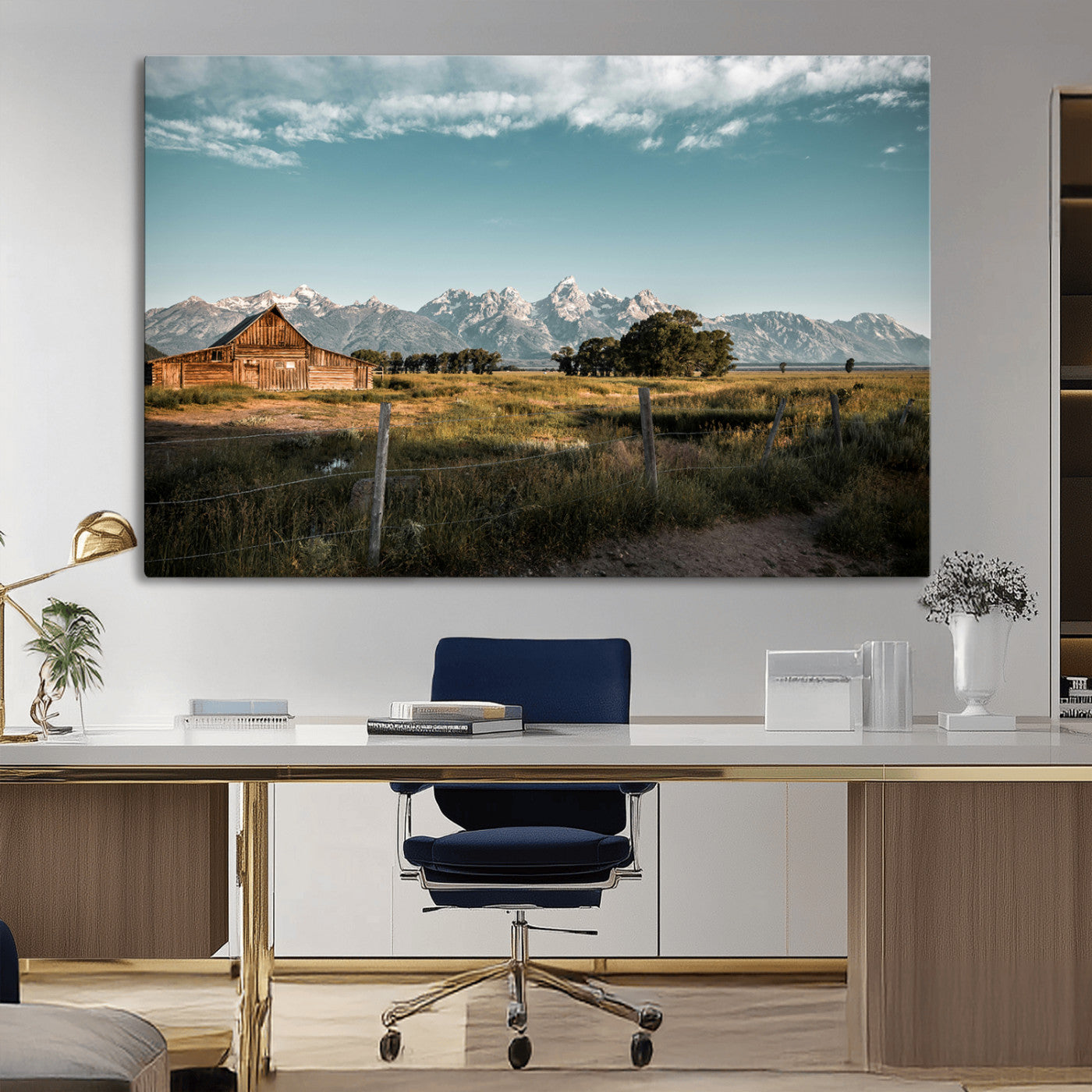 A rustic farmhouse with a wooden barn set against majestic mountain peaks under a soft blue sky, evoking peaceful countryside charm.