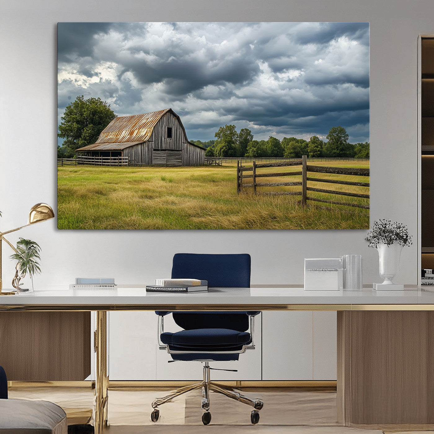 "Rustic barn in a wide open field under a dramatic sky with dark clouds, surrounded by a wooden fence and lush green trees."