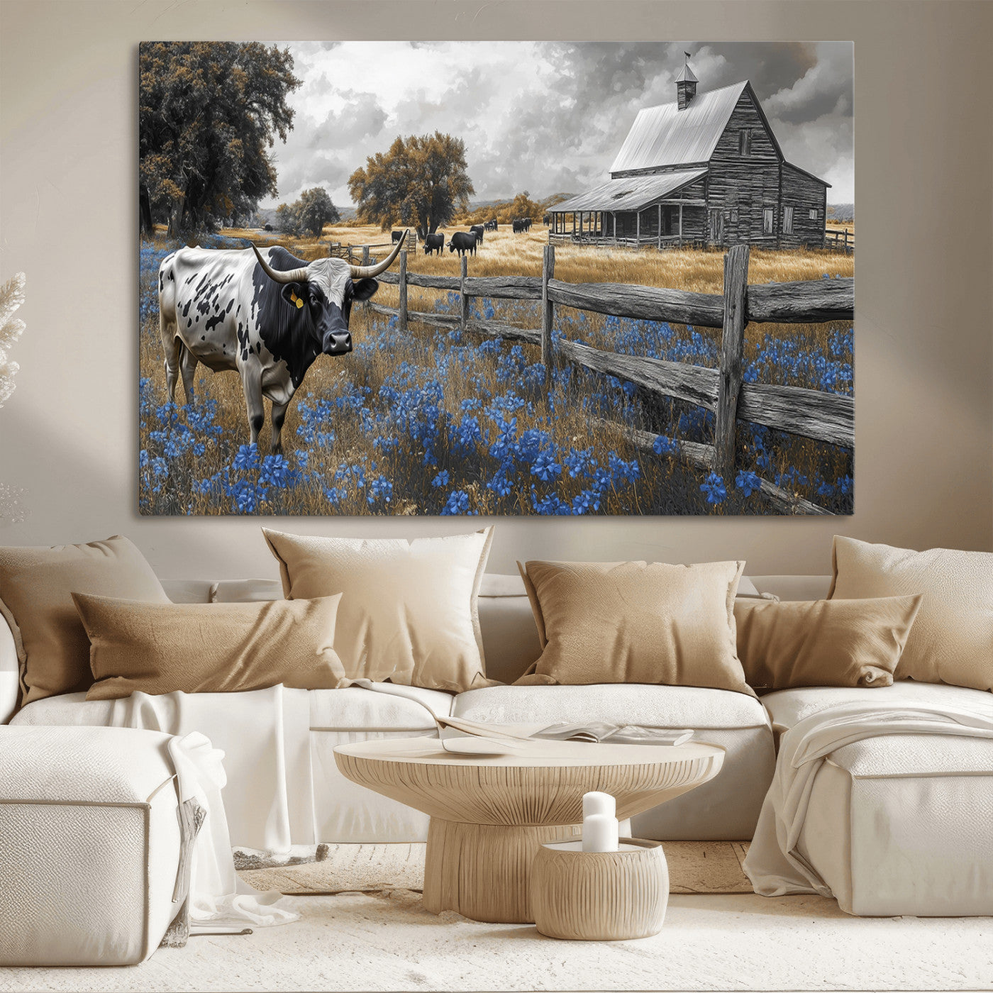 A Texas longhorn stands in front of a rustic barn and wooden fence, with bluebonnets and grazing cattle under dramatic skies.