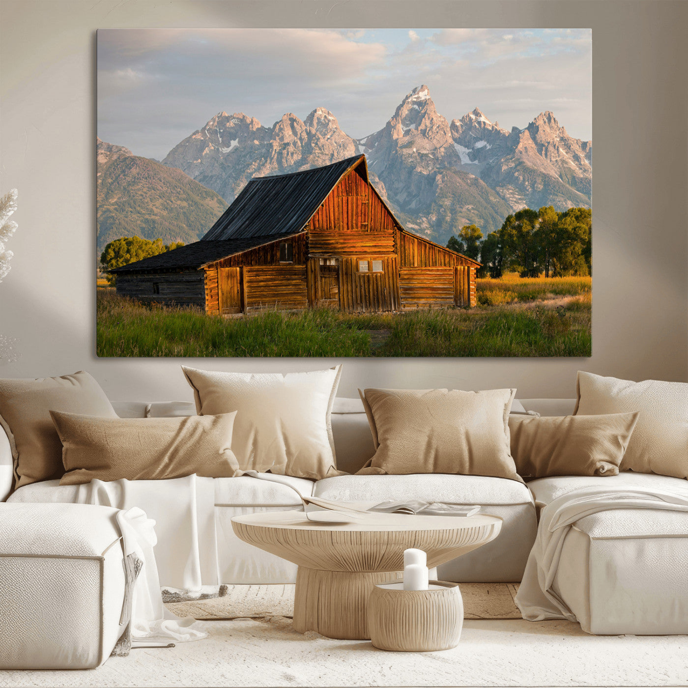 Rustic wooden barn set against towering mountain peaks under warm golden light, creating a peaceful Western countryside scene.