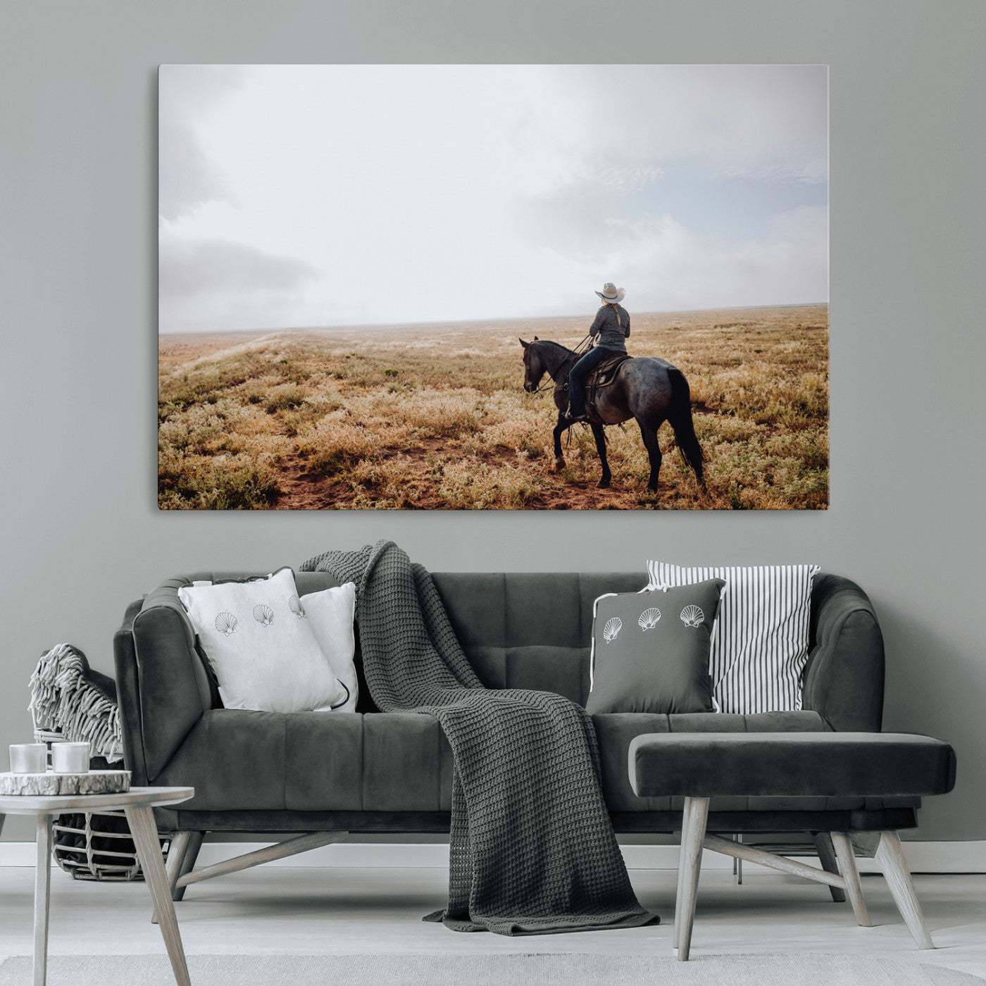 A lone cowboy riding horseback across an open prairie under a vast sky, capturing the rugged and timeless spirit of the Western frontier.