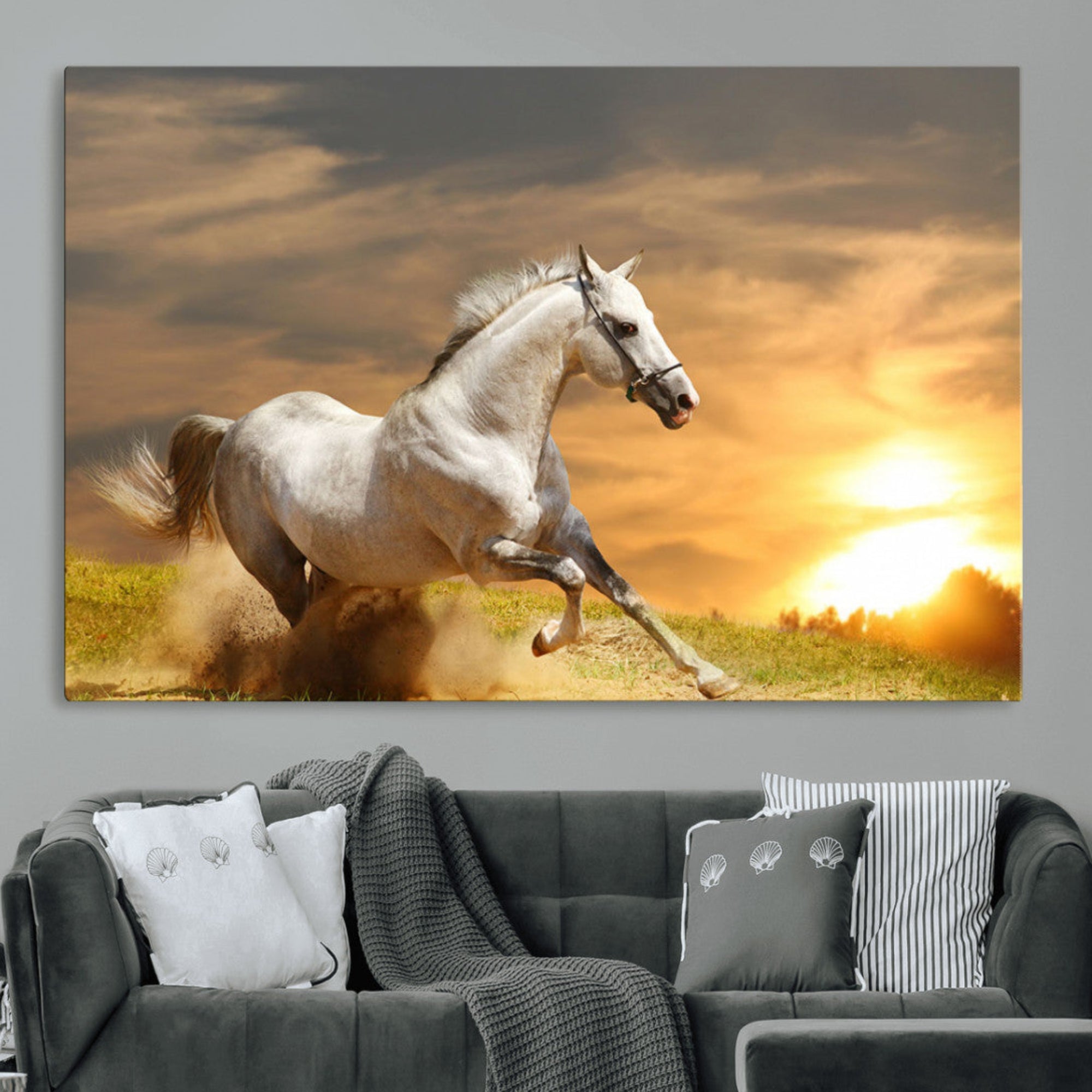 A powerful white horse galloping through the field at sunset, with the golden light illuminating its mane and the vibrant sky in the background.