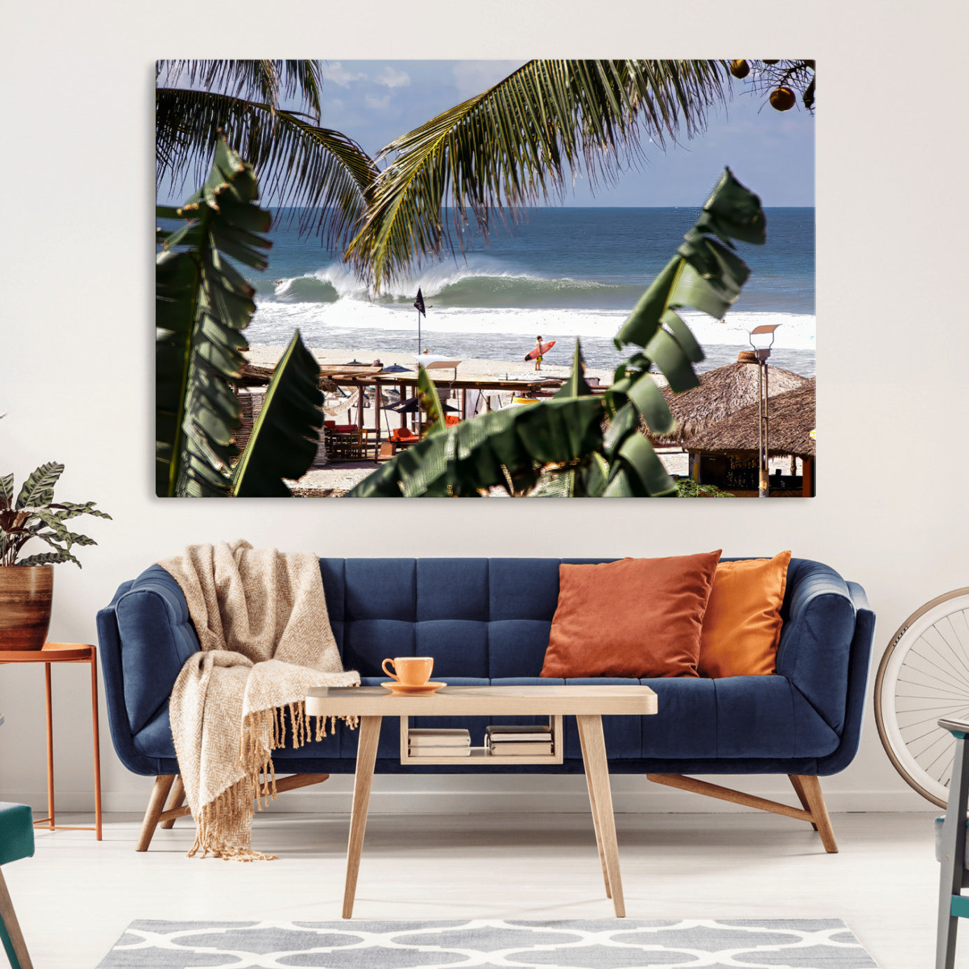 Canvas wall art of a tropical surf scene framed by palm trees, with a surfer on the shore and waves rolling in, ideal for beach-themed decor.