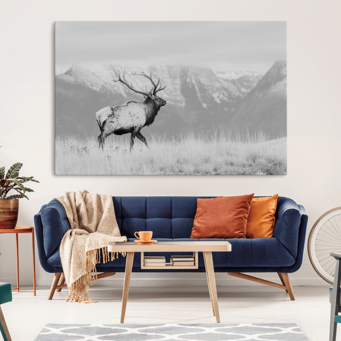 Black and white elk standing in front of snowy mountain range, perfect for rustic lodge or nature-inspired wall decor.