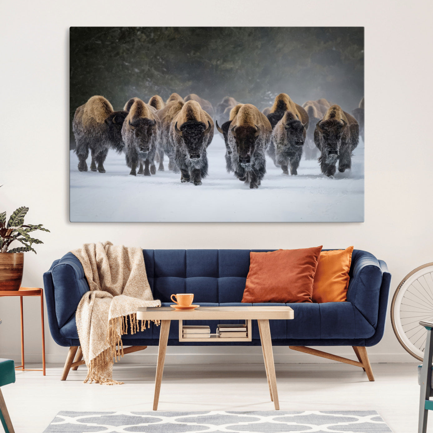 A herd of American bisons walking through deep snow in a forest, evoking a powerful rustic wilderness mood for western-style interiors.