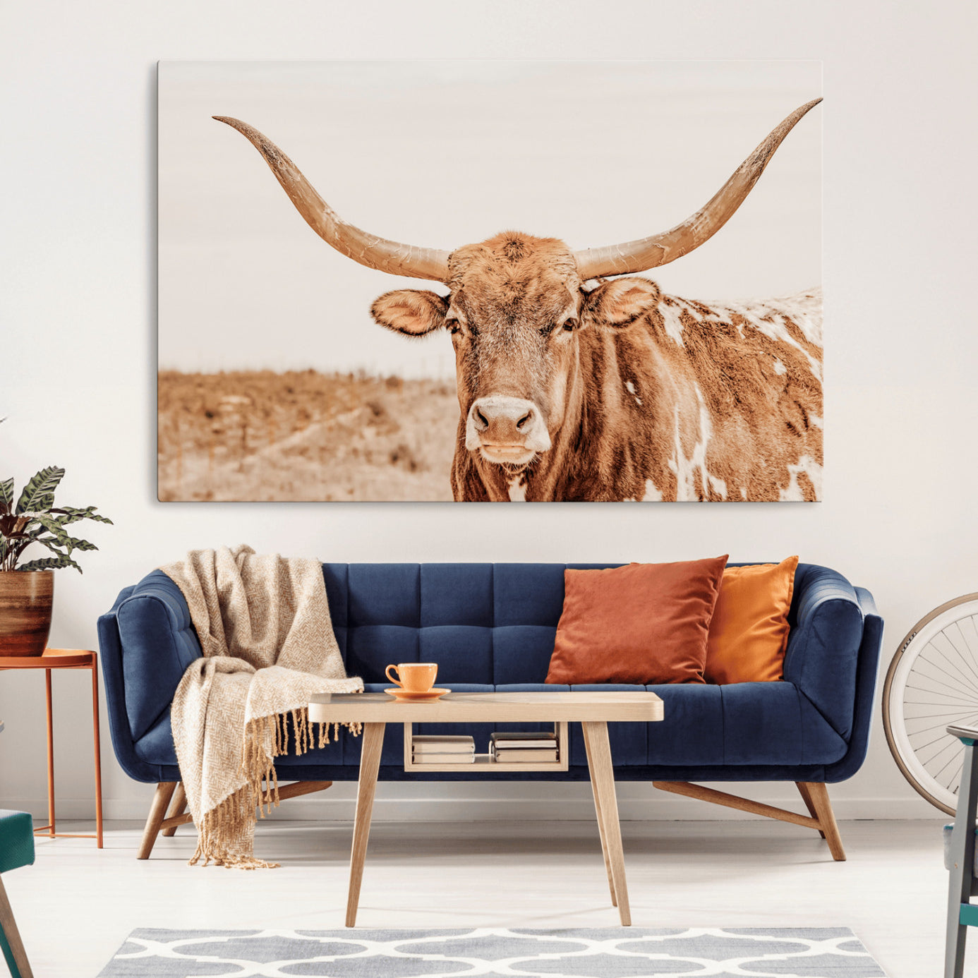 A longhorn bull standing proudly in a sunlit desert field with warm neutral tones, ideal for rustic western or farmhouse interiors.