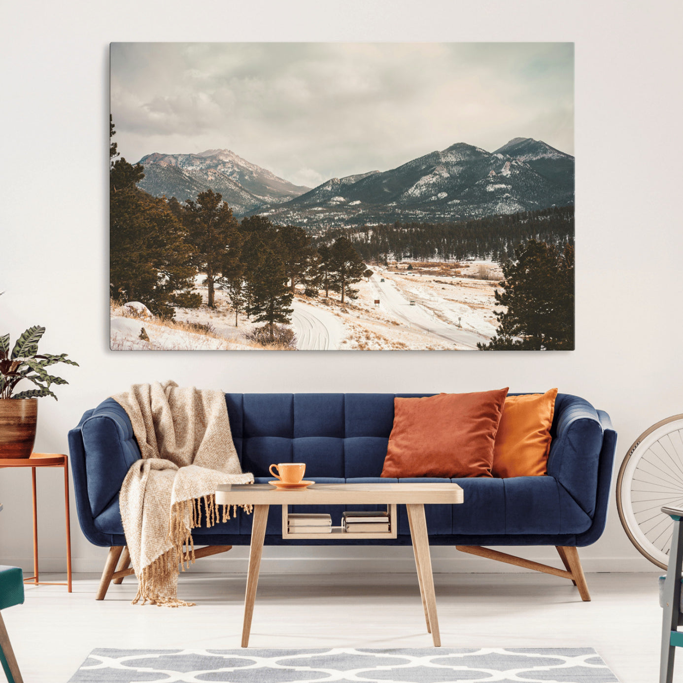 Snow-covered mountains with pine trees and a winding path, creating a serene and rustic winter landscape perfect for cozy decor.