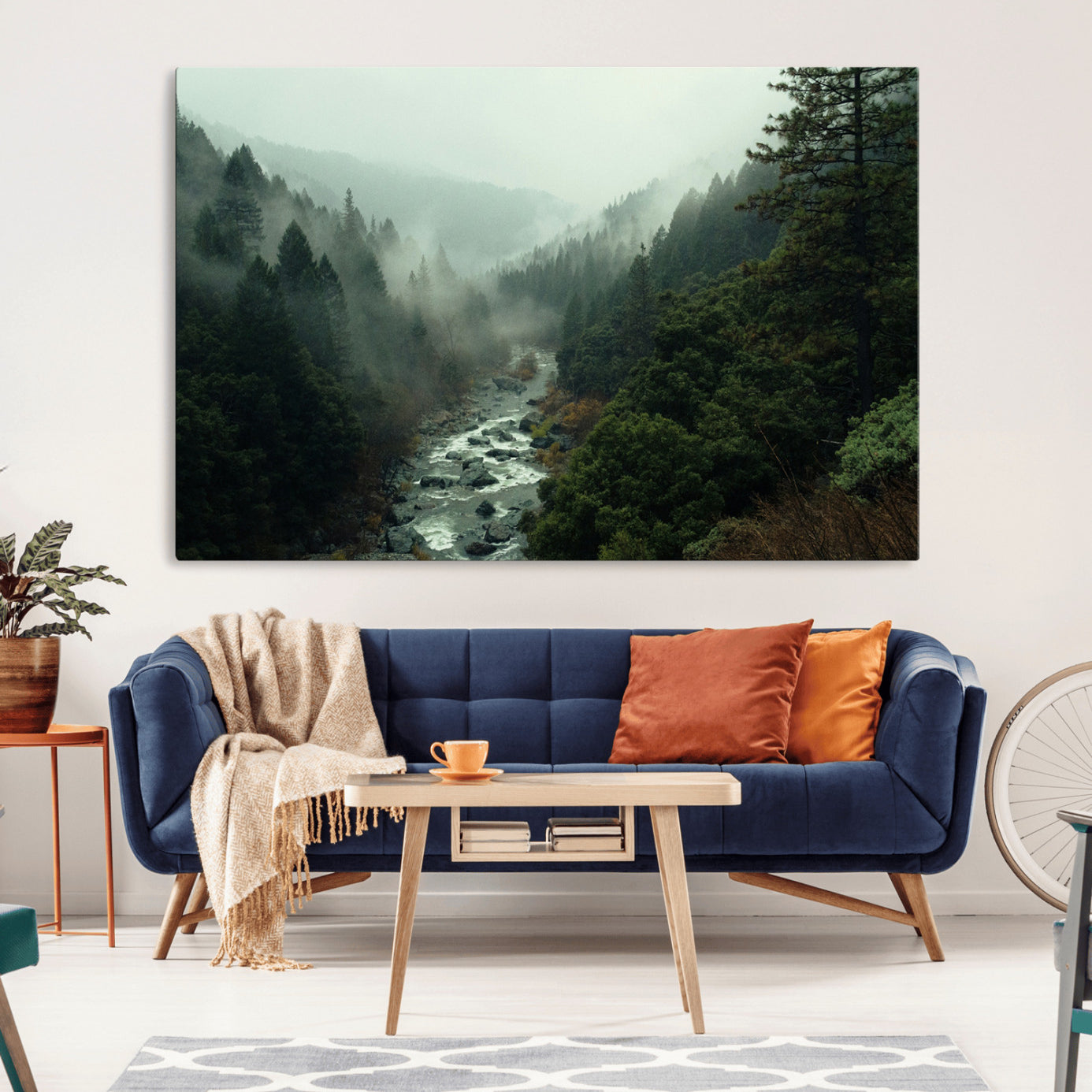 Misty forest with a winding river flowing through lush green mountains, creating a tranquil and moody wilderness landscape.