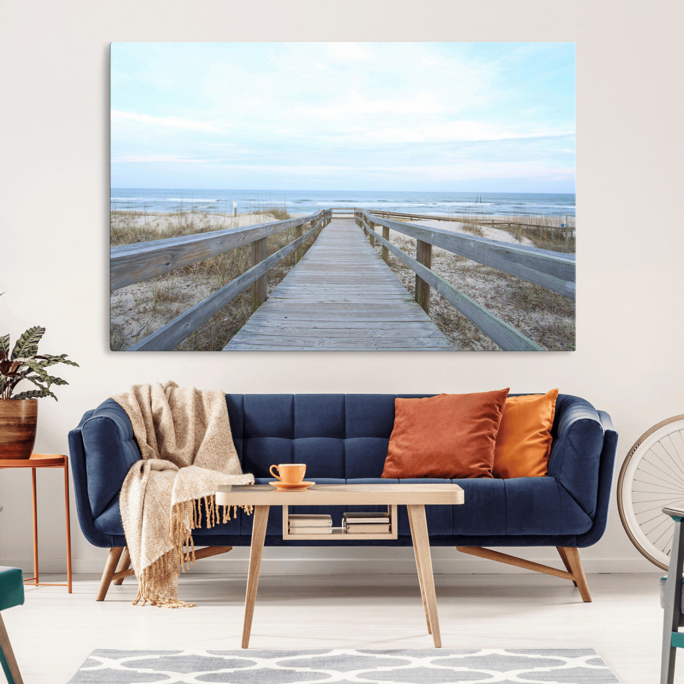 Wooden boardwalk leading to a peaceful beach with gentle ocean waves under a soft pastel sky, perfect for coastal and nautical home decor.