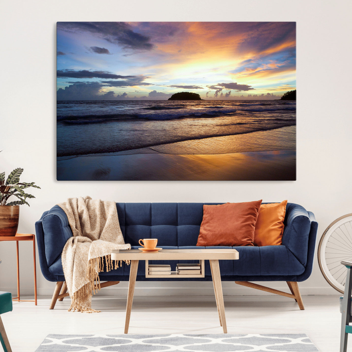 A tropical beach at sunset with waves gently washing ashore, reflecting golden and purple hues in the sky, creating a tranquil coastal scene.