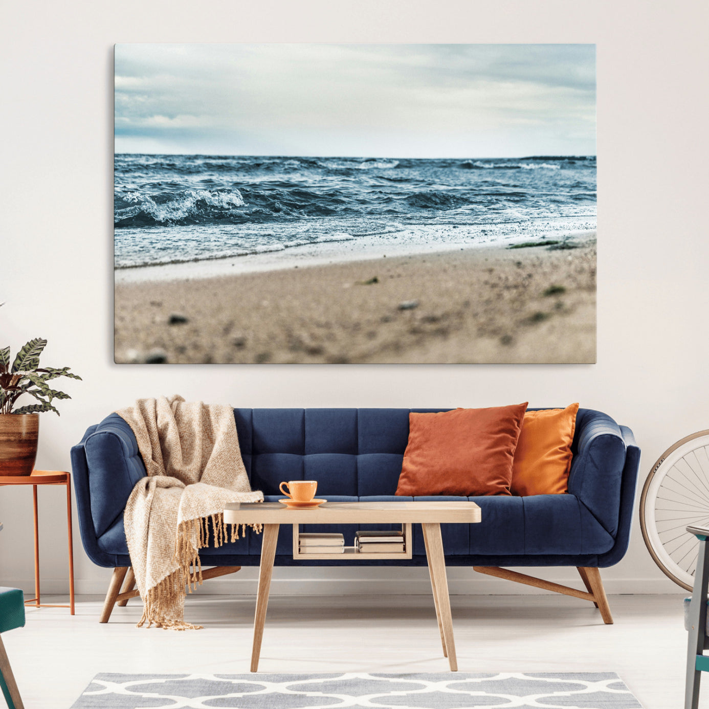 A moody ocean scene with gentle waves washing onto a sandy beach under a cloudy sky, creating a peaceful and coastal atmosphere.