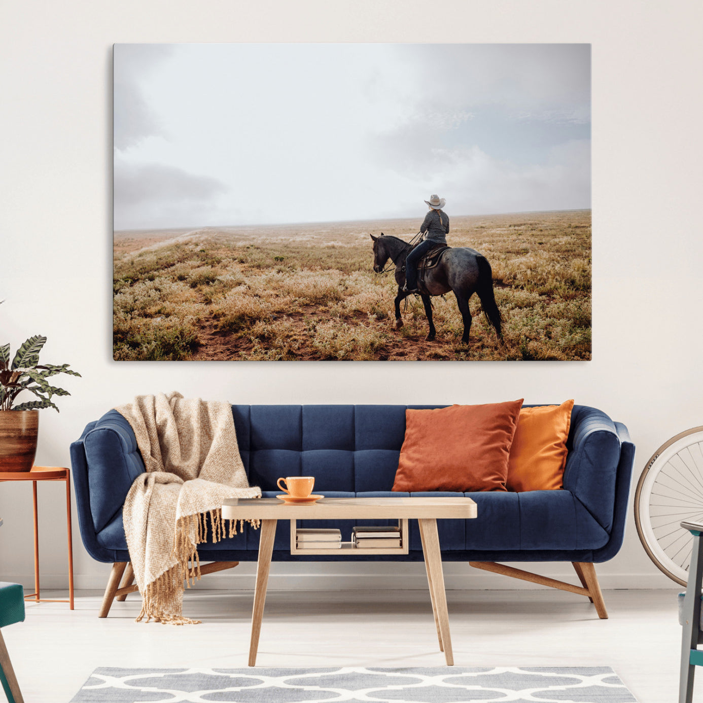 A lone cowboy riding horseback across an open prairie under a vast sky, capturing the rugged and timeless spirit of the Western frontier.
