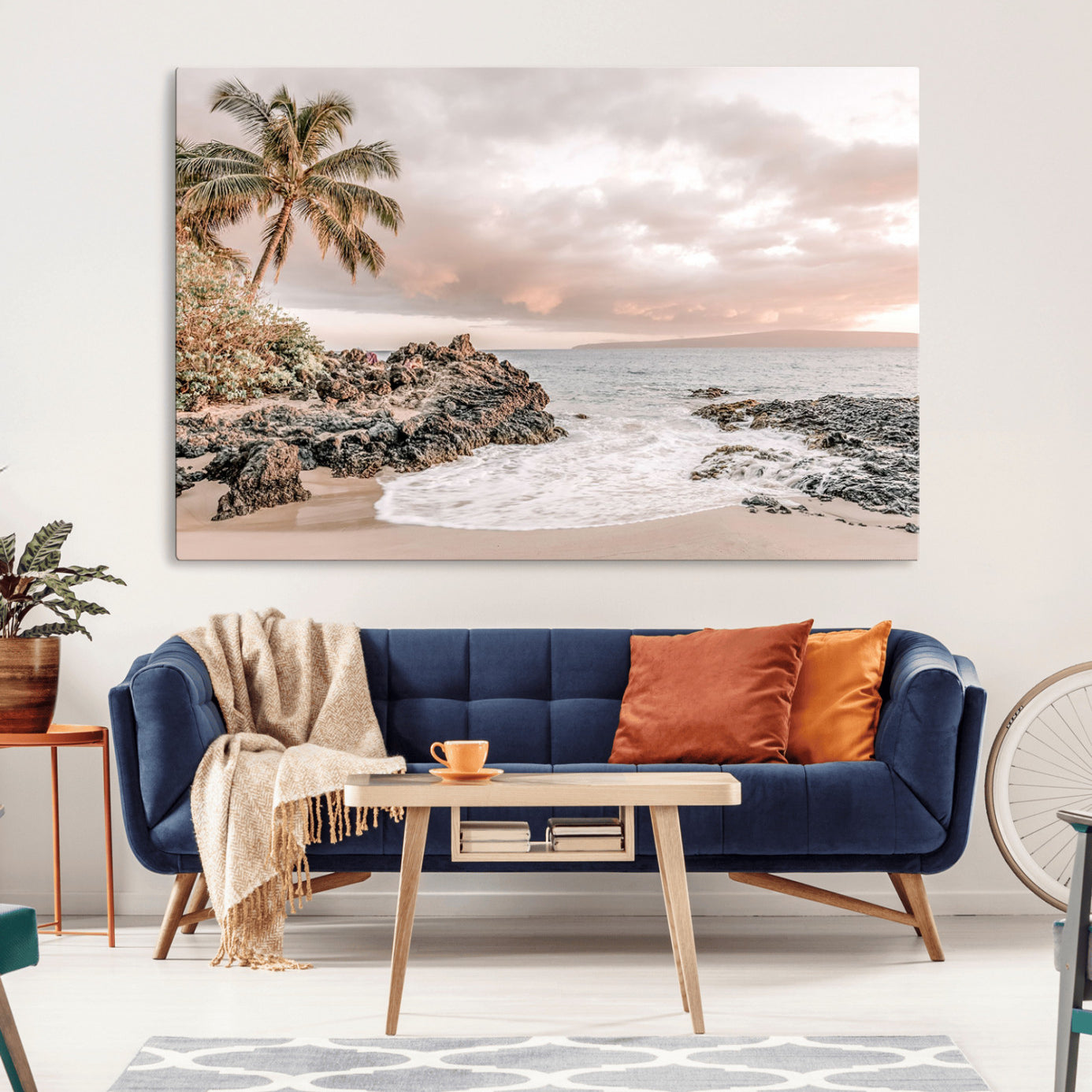A peaceful beach scene with a palm tree and rocks, soft waves washing onto the shore under a soft pastel sky at sunset.