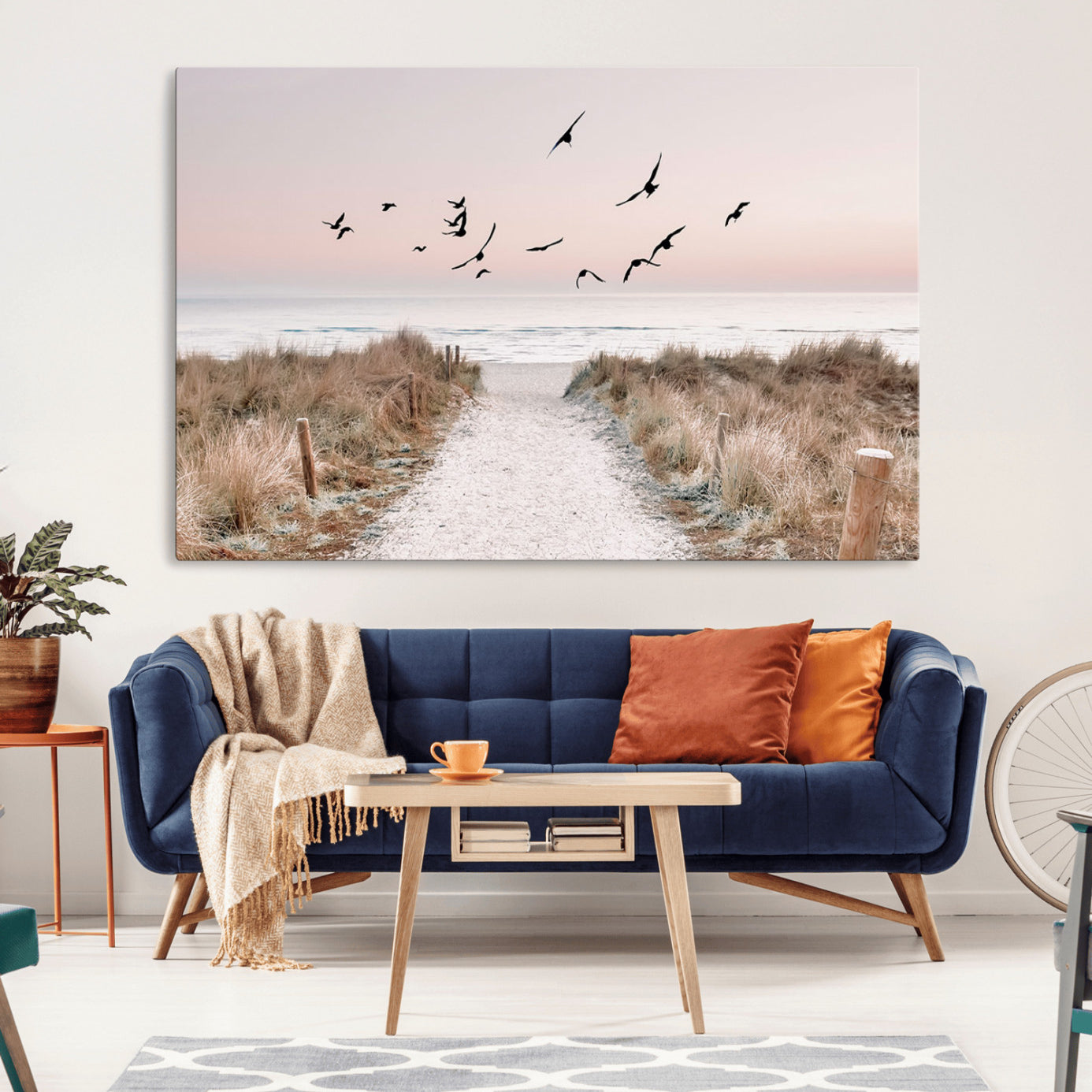 A peaceful coastal pathway leading to the ocean, with birds flying across a soft pastel sky, creating a calm and scenic beach atmosphere.