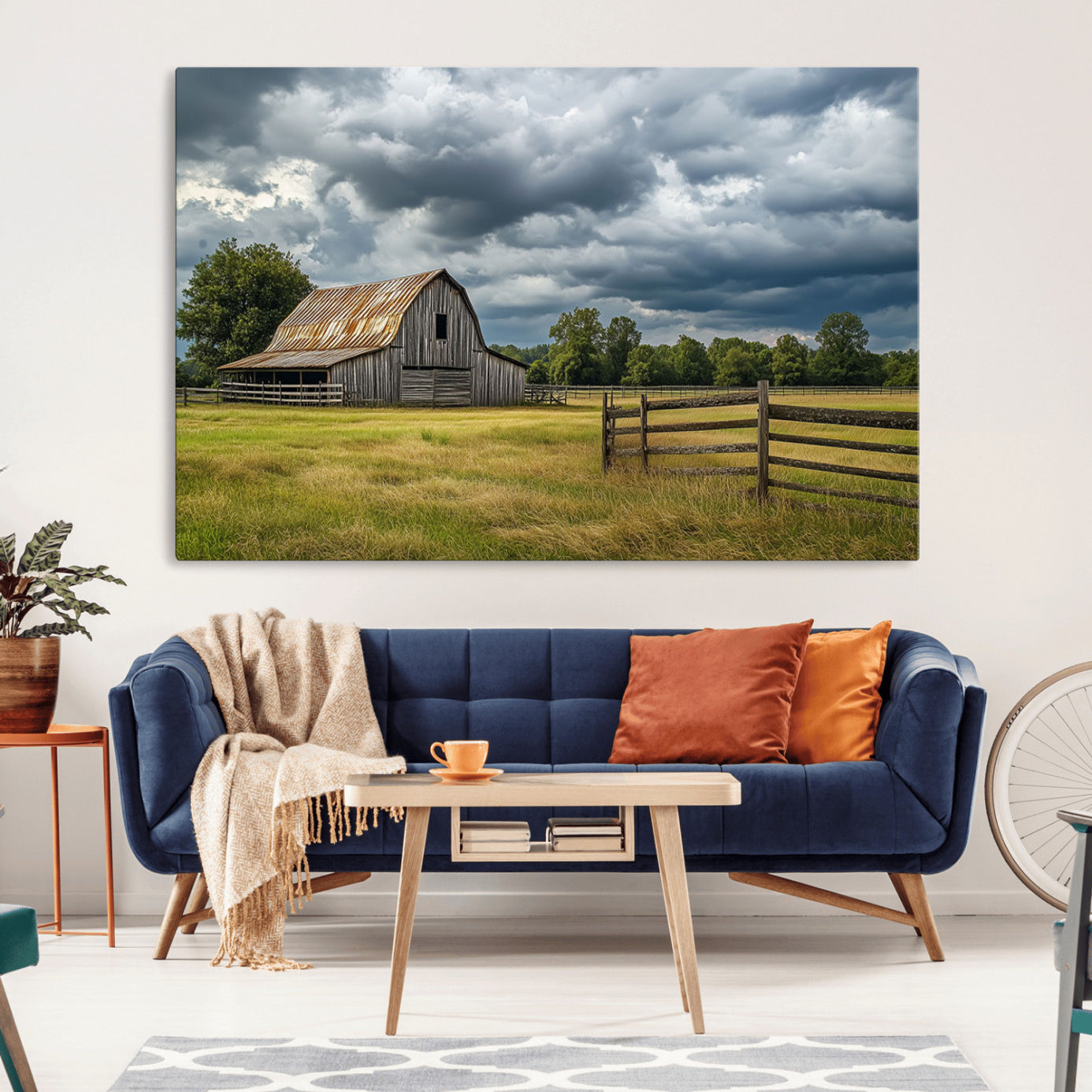 "Rustic barn in a wide open field under a dramatic sky with dark clouds, surrounded by a wooden fence and lush green trees."