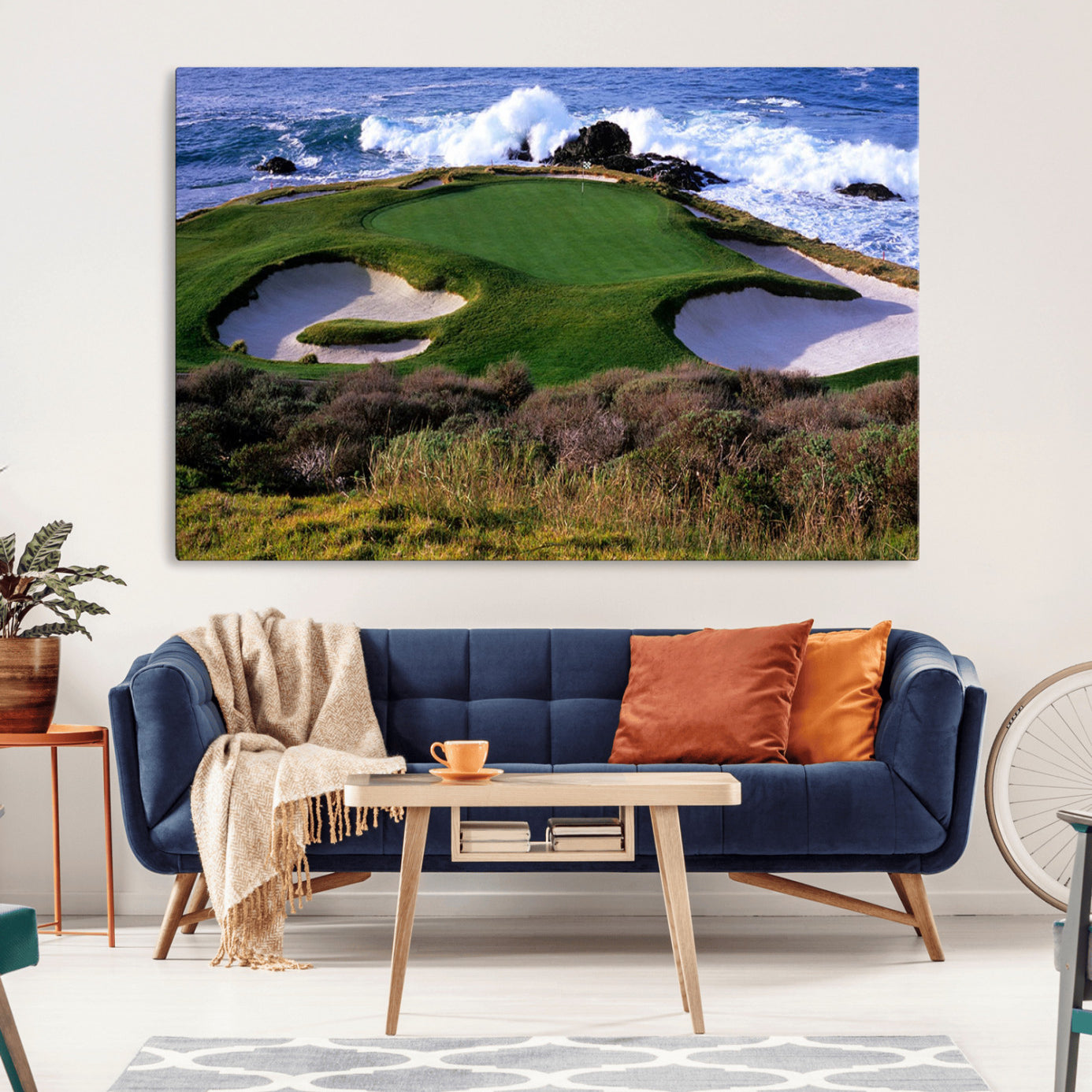 A scenic golf course located by the ocean, featuring a well-manicured green surrounded by sand traps and powerful ocean waves crashing on the shore.