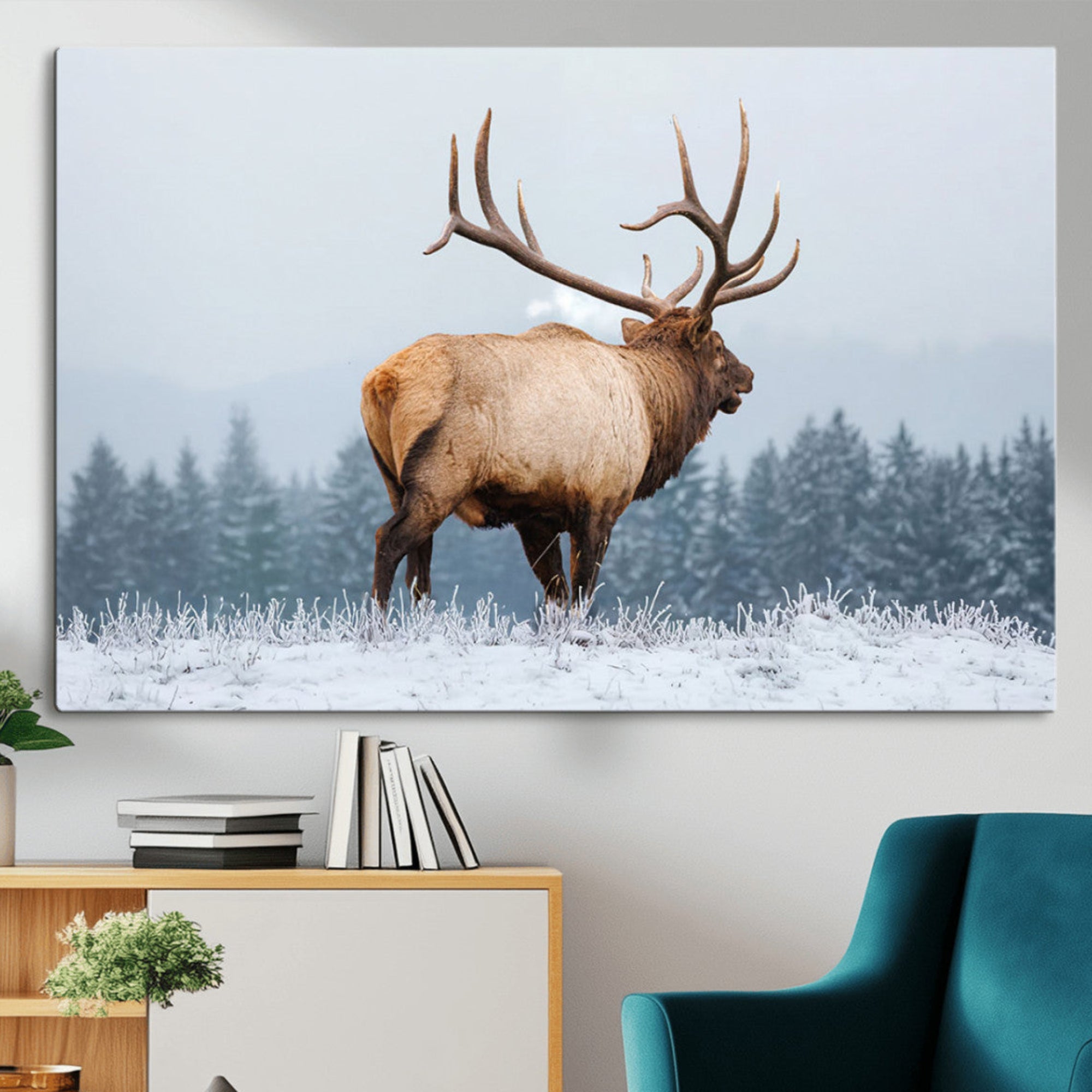 A majestic elk standing in a snowy landscape, with large antlers, set against a backdrop of evergreen trees and a soft winter sky.