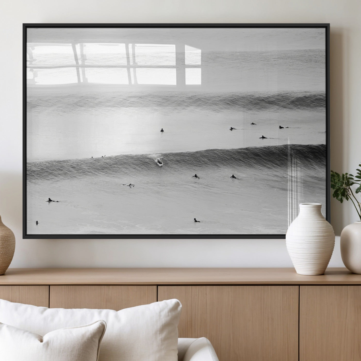 A monochrome photograph of swimmers gliding through gentle ocean waves, evoking a sense of calm and movement.