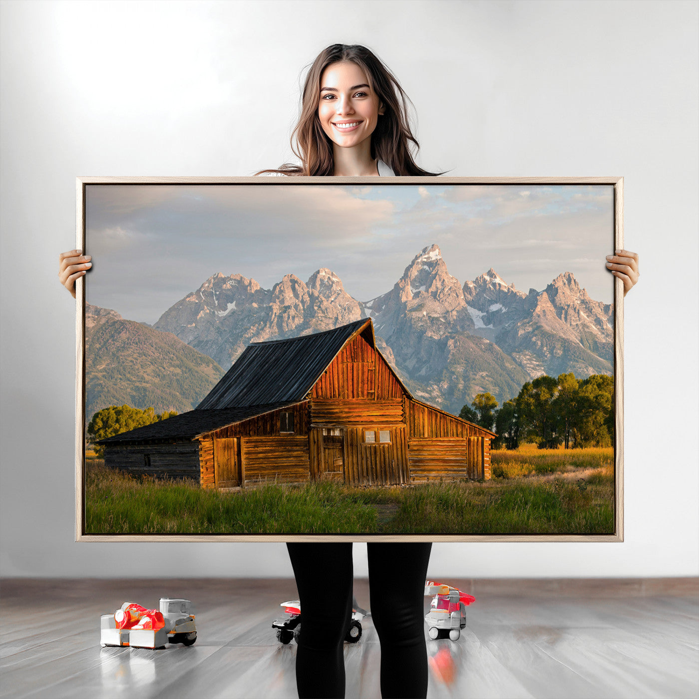 Rustic wooden barn set against towering mountain peaks under warm golden light, creating a peaceful Western countryside scene.