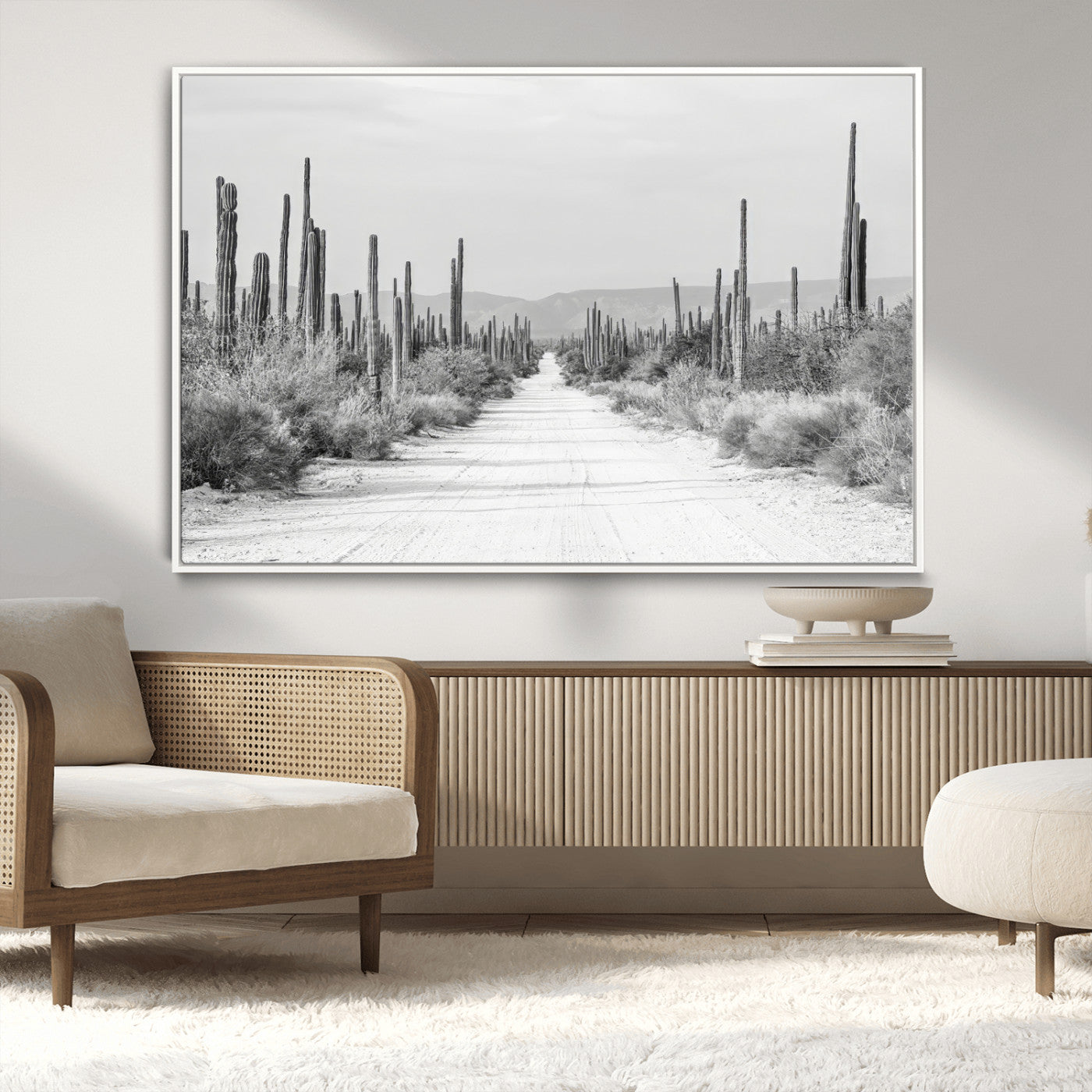 A black and white desert road stretching through a cactus-filled landscape, creating a rugged and timeless southwestern aesthetic with a sense of adventure.