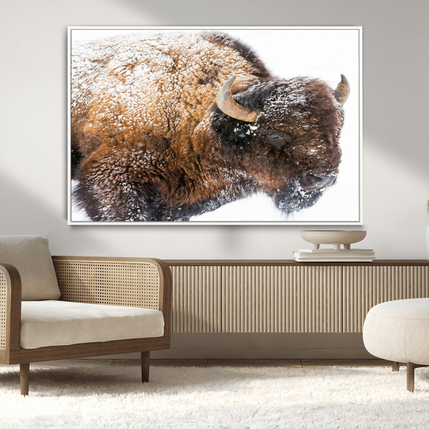 Close-up photograph of a bison covered in snow, highlighting its thick fur and powerful presence, set against a white winter backdrop, ideal for rustic decor.