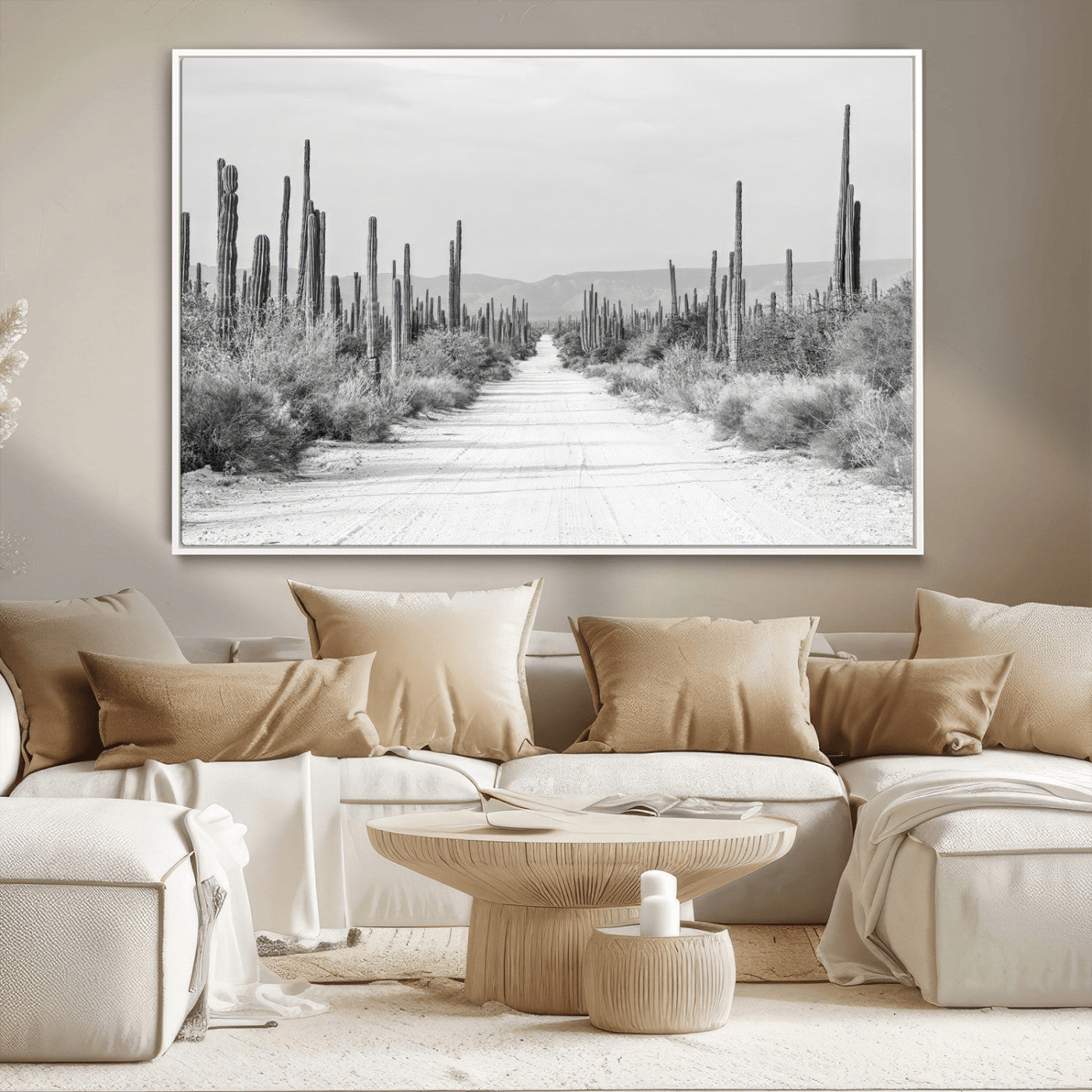 A black and white desert road stretching through a cactus-filled landscape, creating a rugged and timeless southwestern aesthetic with a sense of adventure.