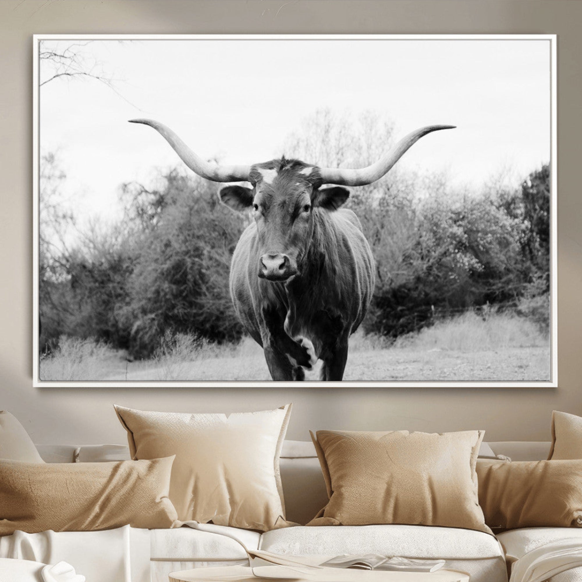 Black and white photo of a Longhorn cow facing camera, ideal for rustic, farmhouse, or western-themed home wall decor.