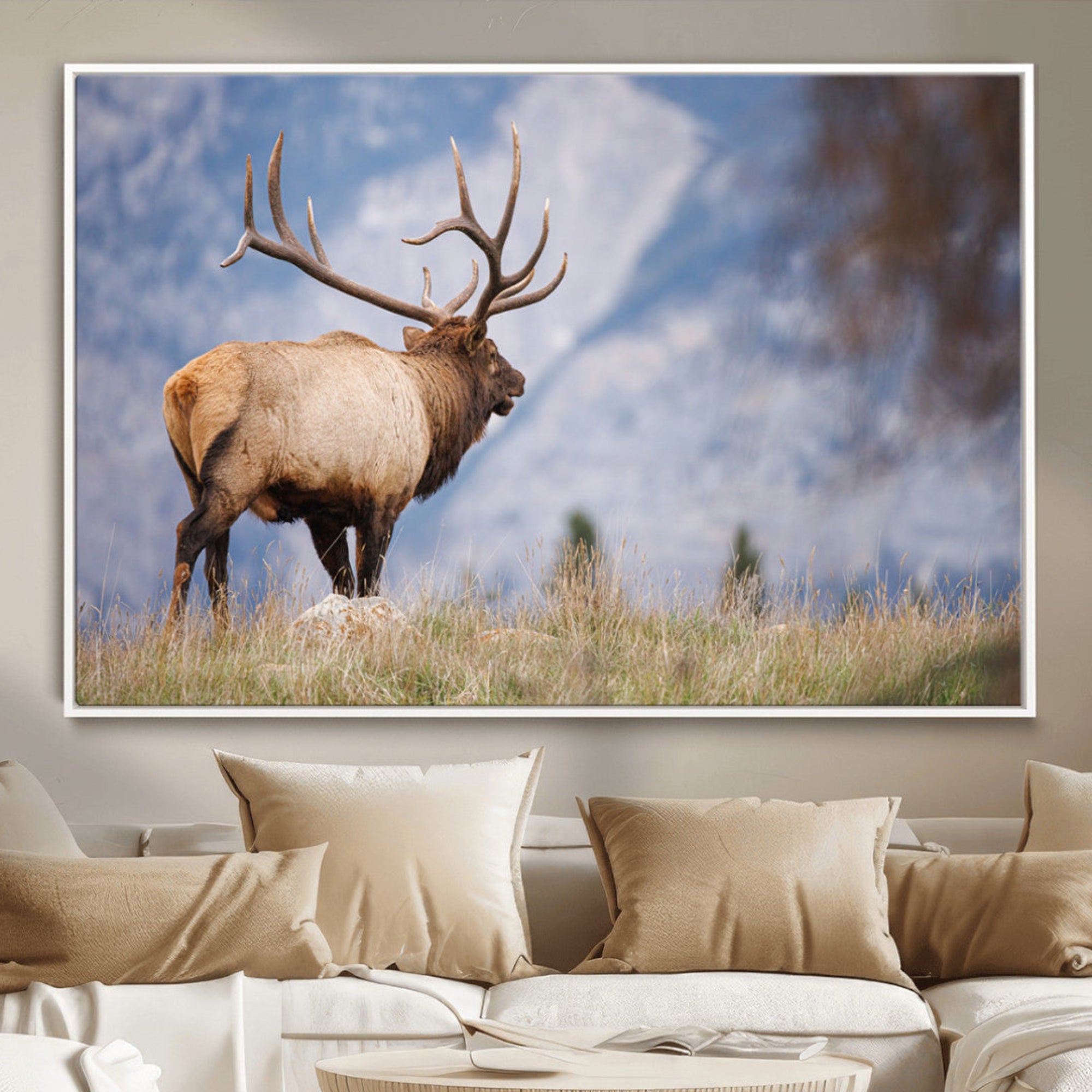 Elk with antlers standing on grass with mountain background, ideal for rustic, cabin, or lodge-inspired wall decor.