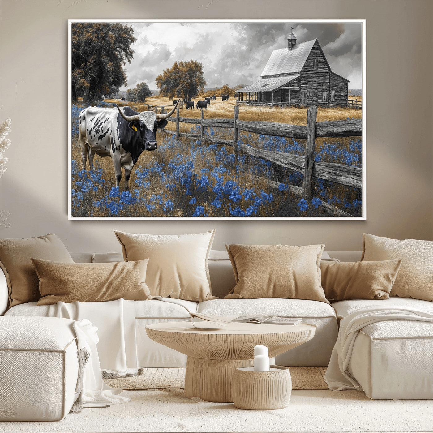 A Texas longhorn stands in front of a rustic barn and wooden fence, with bluebonnets and grazing cattle under dramatic skies.