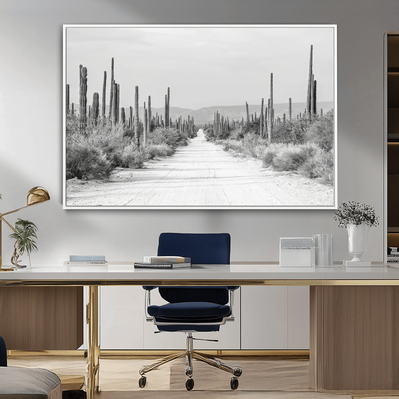 A black and white desert road stretching through a cactus-filled landscape, creating a rugged and timeless southwestern aesthetic with a sense of adventure.