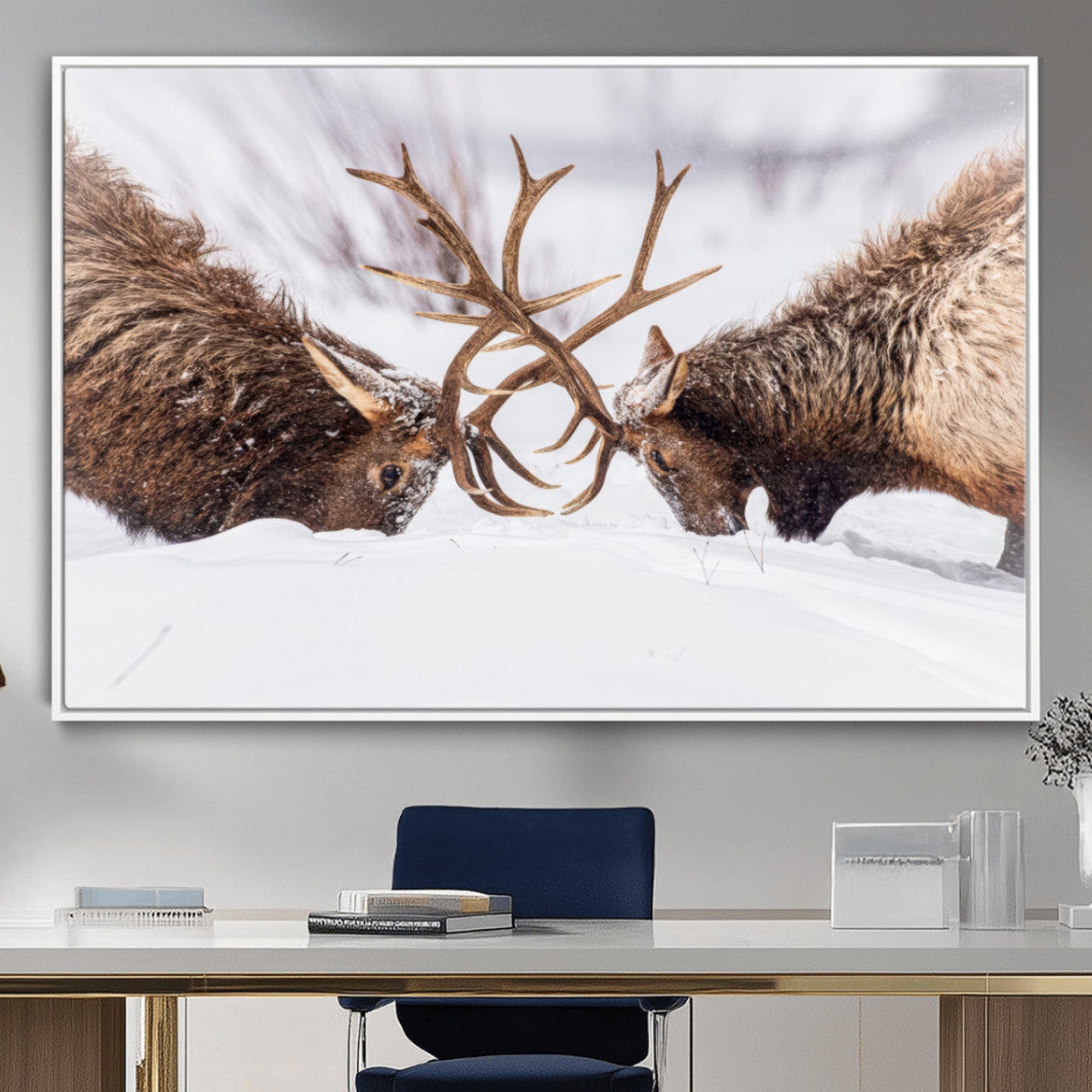 A dramatic wall art canvas print showcasing two majestic elk locking antlers in a snowy winter landscape, capturing the raw power and beauty of wildlife, ideal for nature-inspired home decor.
