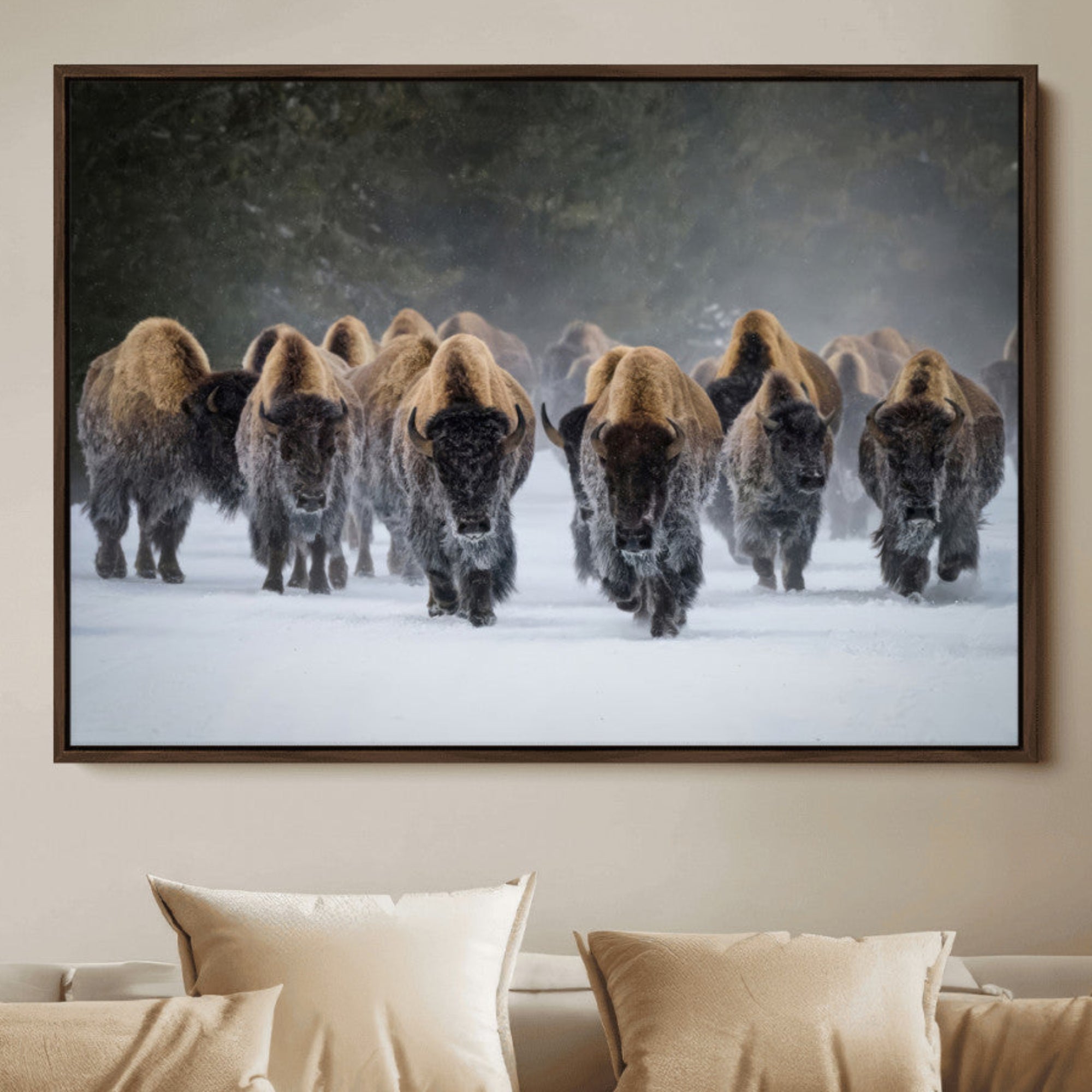 A herd of American bisons walking through deep snow in a forest, evoking a powerful rustic wilderness mood for western-style interiors.