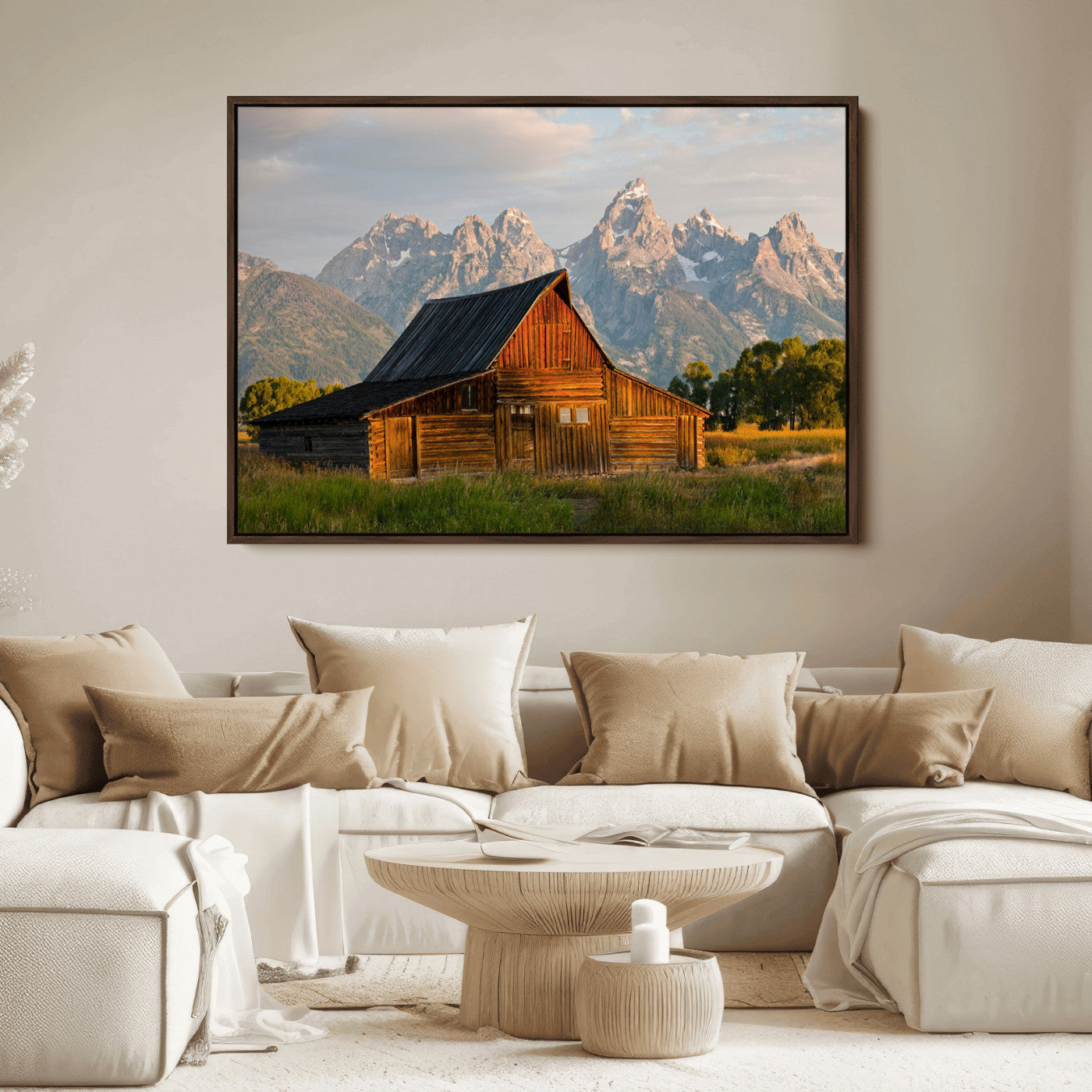 Rustic wooden barn set against towering mountain peaks under warm golden light, creating a peaceful Western countryside scene.