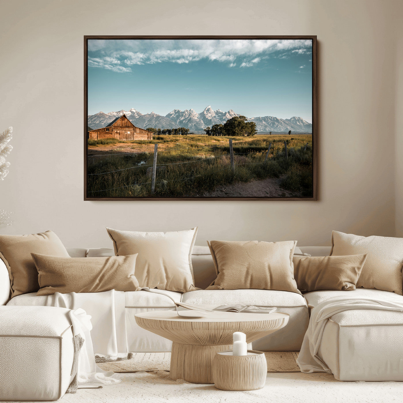 A rustic farmhouse with a wooden barn set against majestic mountain peaks under a soft blue sky, evoking peaceful countryside charm.