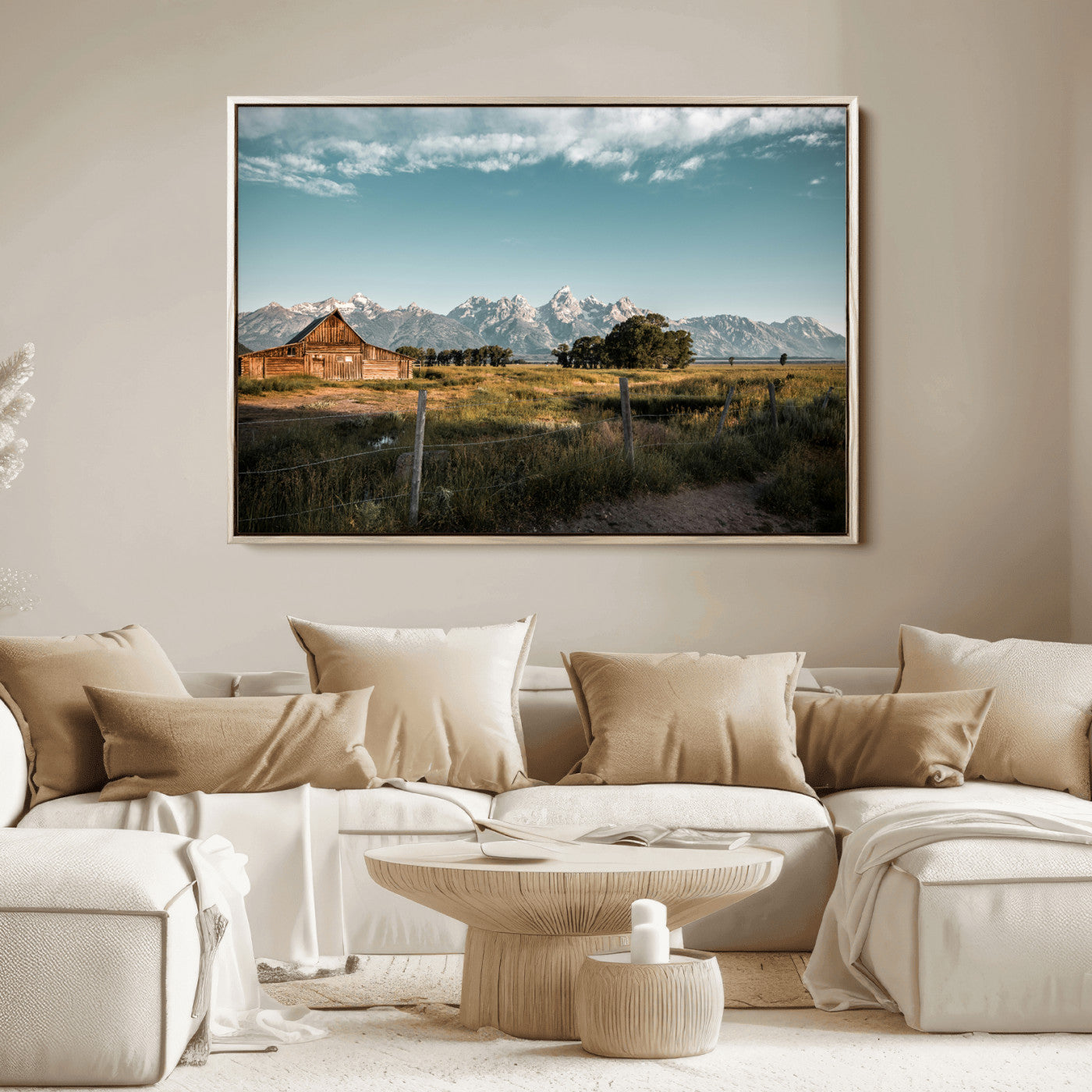 A rustic farmhouse with a wooden barn set against majestic mountain peaks under a soft blue sky, evoking peaceful countryside charm.