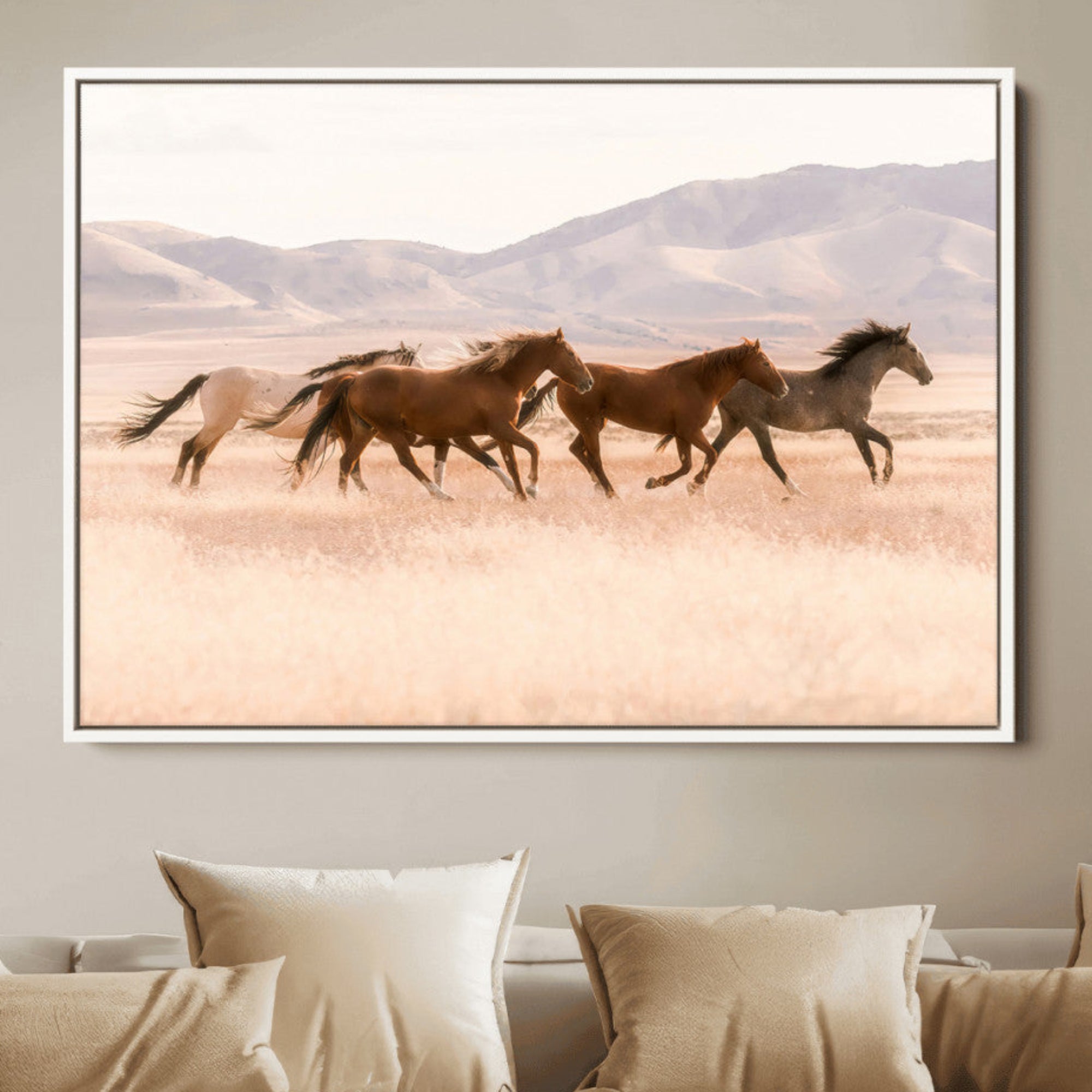 A herd of wild horses galloping through a sunlit desert plain with mountains in the background, perfect for rustic or western-themed wall decor.