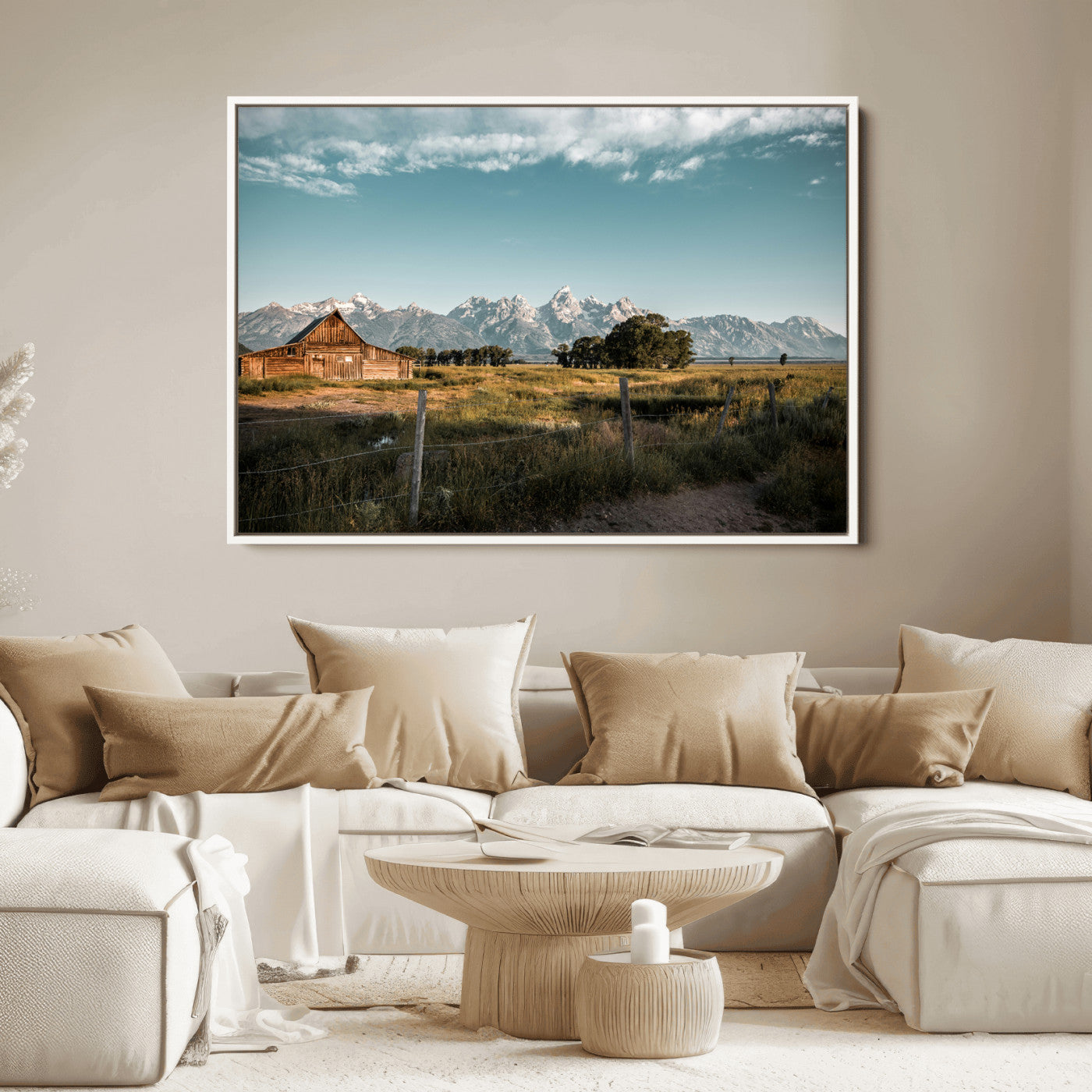 A rustic farmhouse with a wooden barn set against majestic mountain peaks under a soft blue sky, evoking peaceful countryside charm.