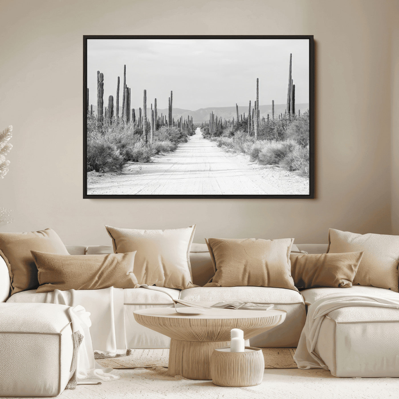 A black and white desert road stretching through a cactus-filled landscape, creating a rugged and timeless southwestern aesthetic with a sense of adventure.