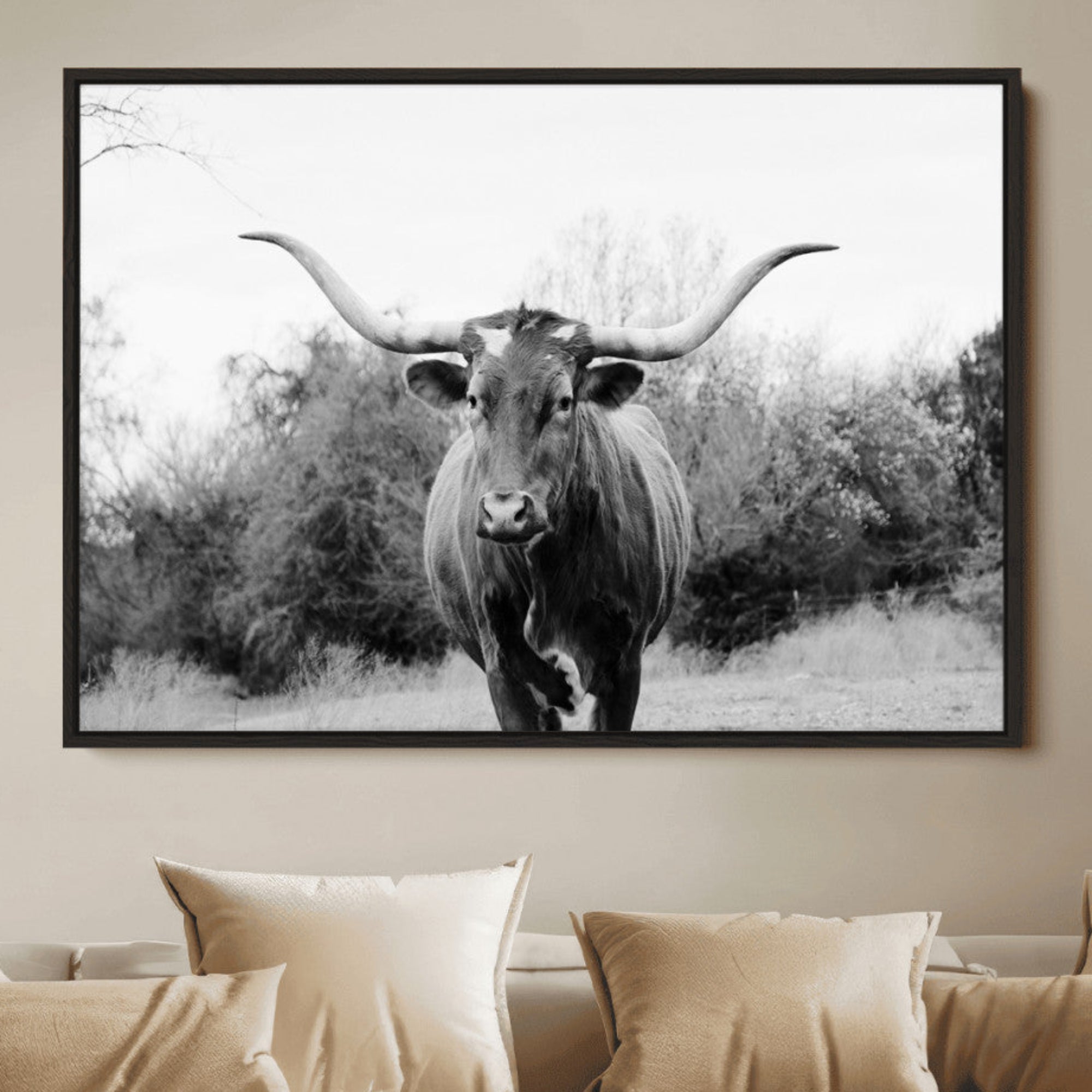Black and white photo of a Longhorn cow facing camera, ideal for rustic, farmhouse, or western-themed home wall decor.