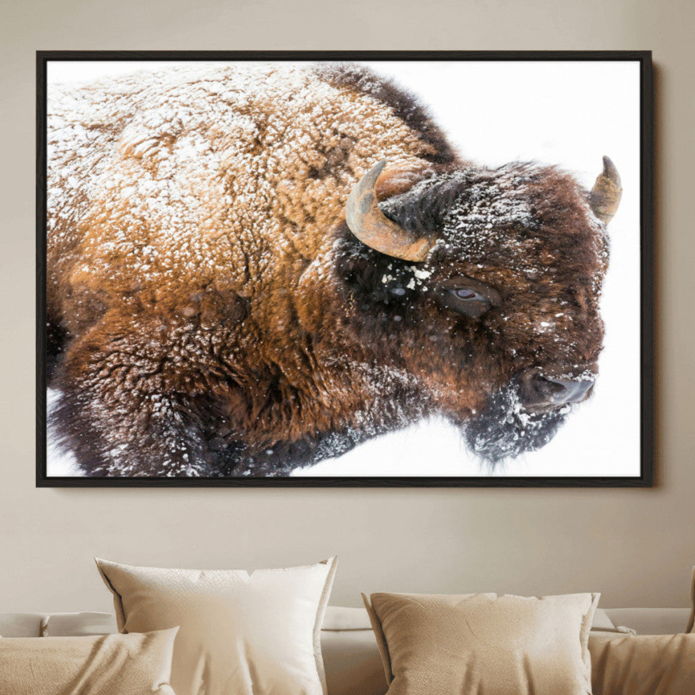 Close-up photograph of a bison covered in snow, highlighting its thick fur and powerful presence, set against a white winter backdrop, ideal for rustic decor.